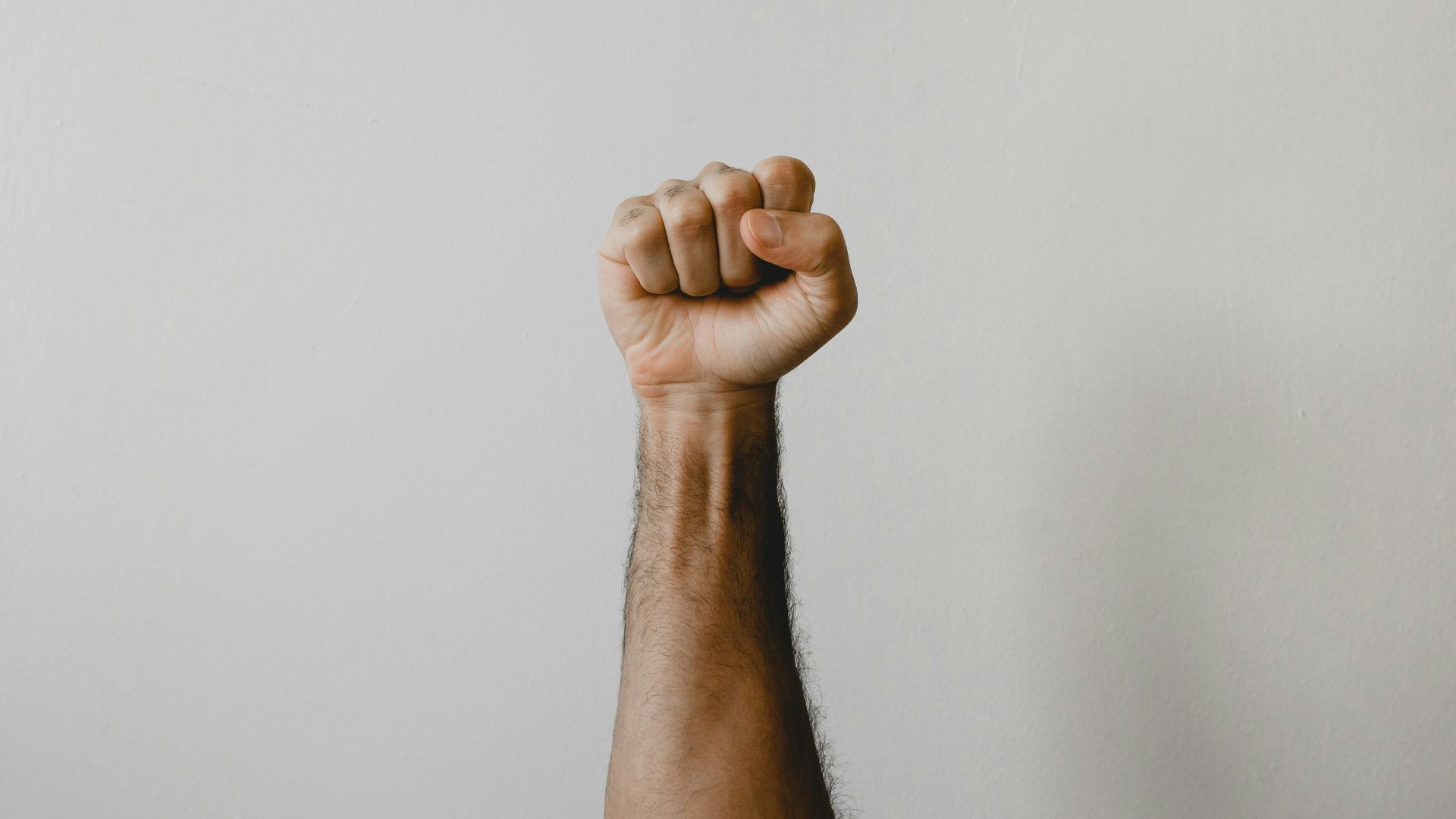 persons right foot on white wall