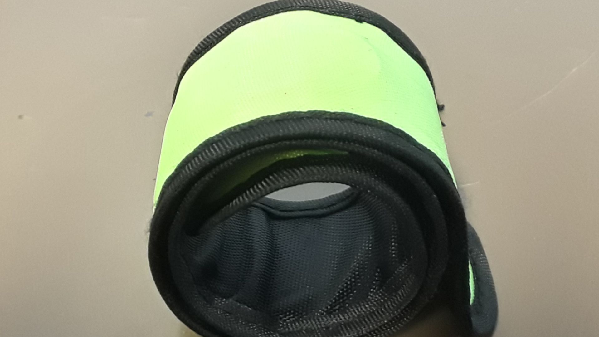 File:Neon green slap bracelet rolled up and seen from overhead at an angle.jpg