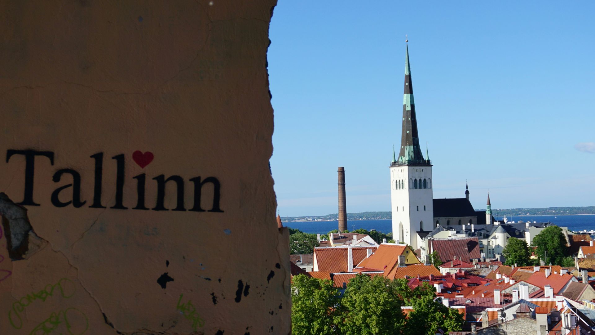 A view of a city with a steeple in the background
