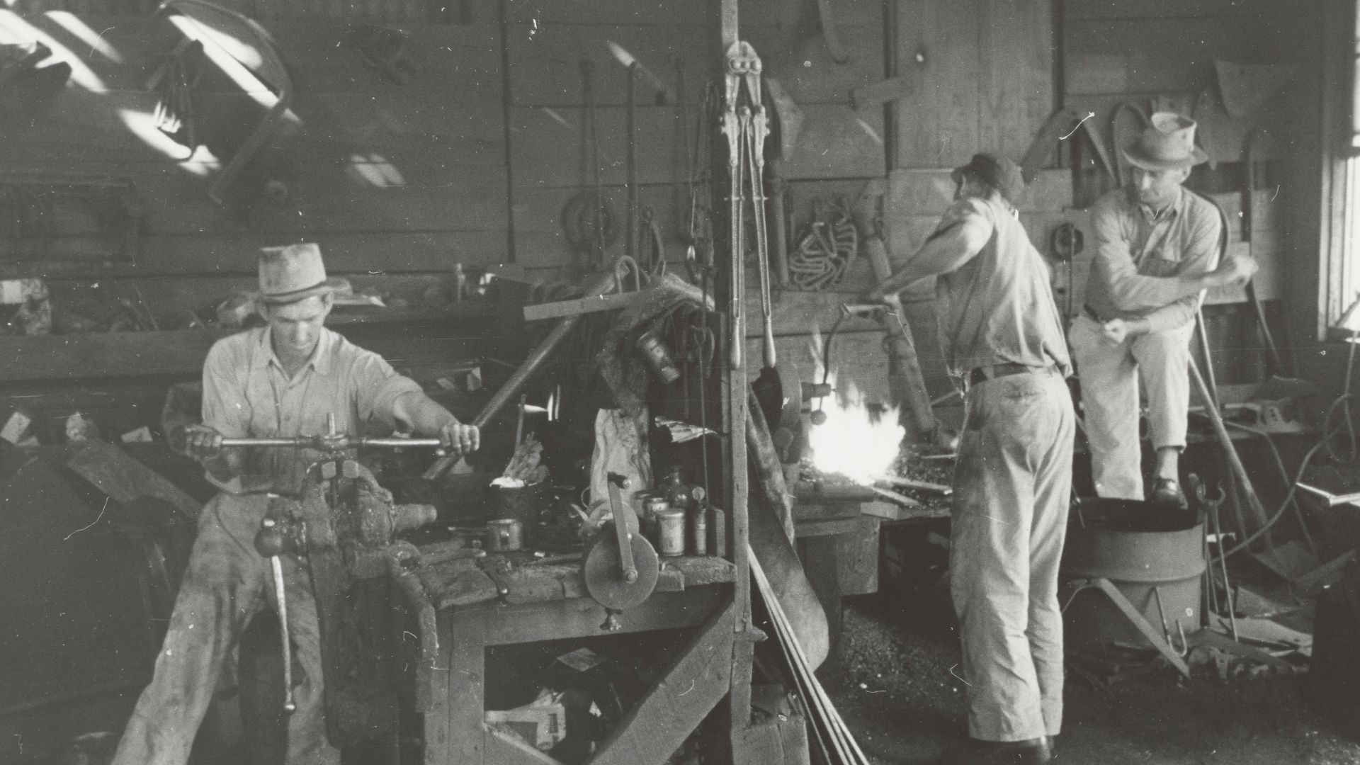 grayscale photography of men working inside building