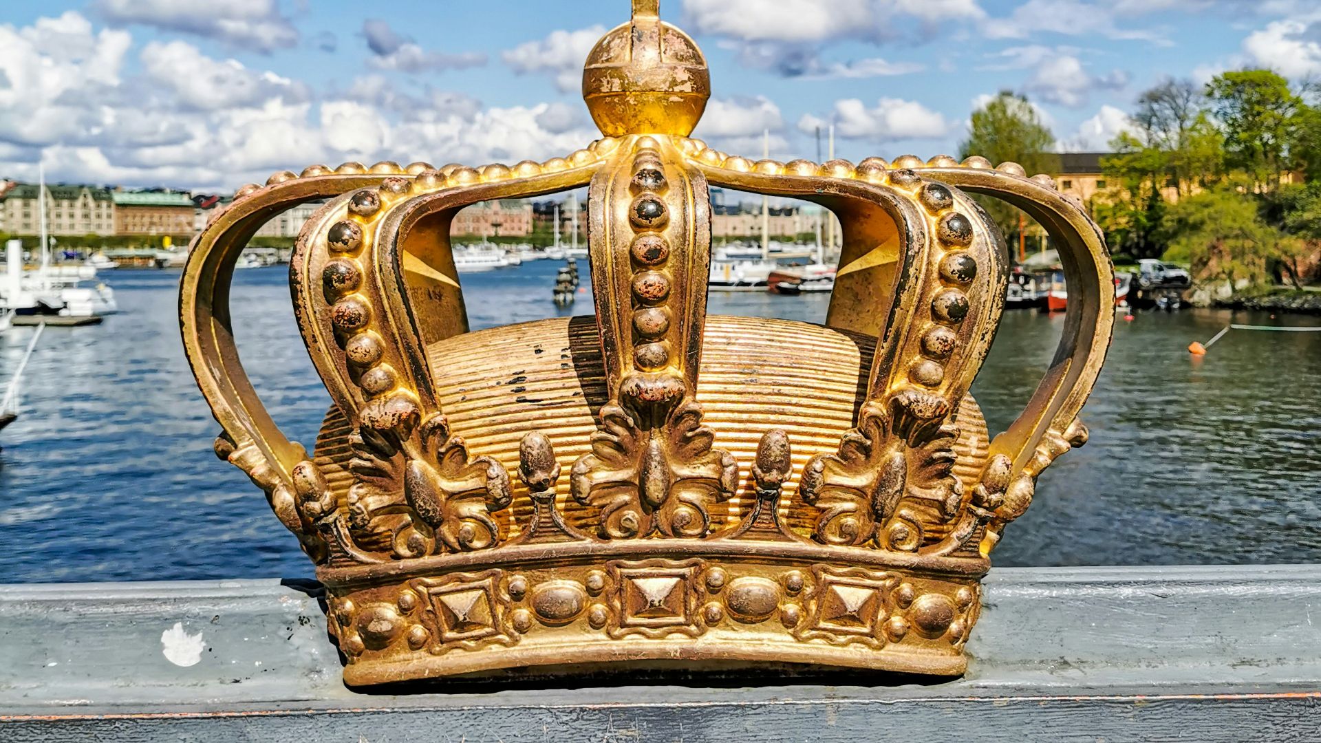 gold crown with a cumulus clouds in the background