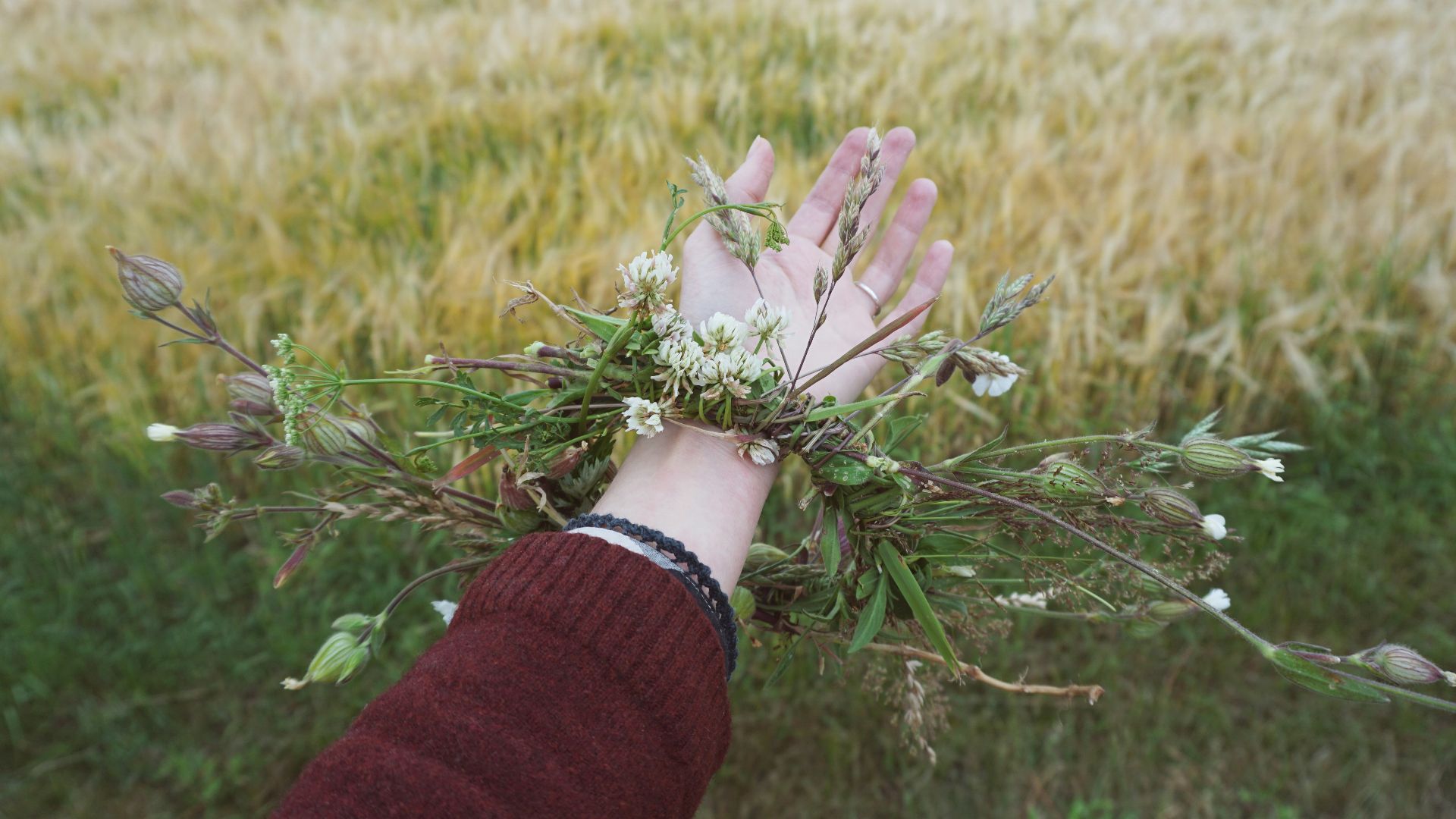 green floral wreath on person's wrist