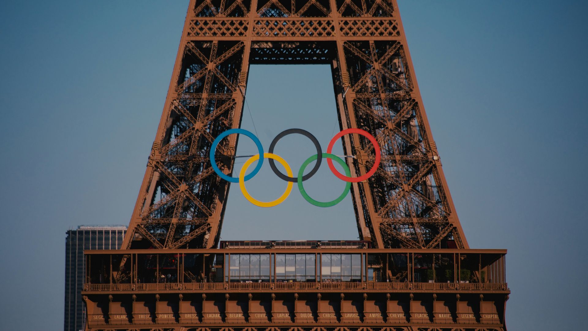The eiffel tower with the olympic rings in front of it