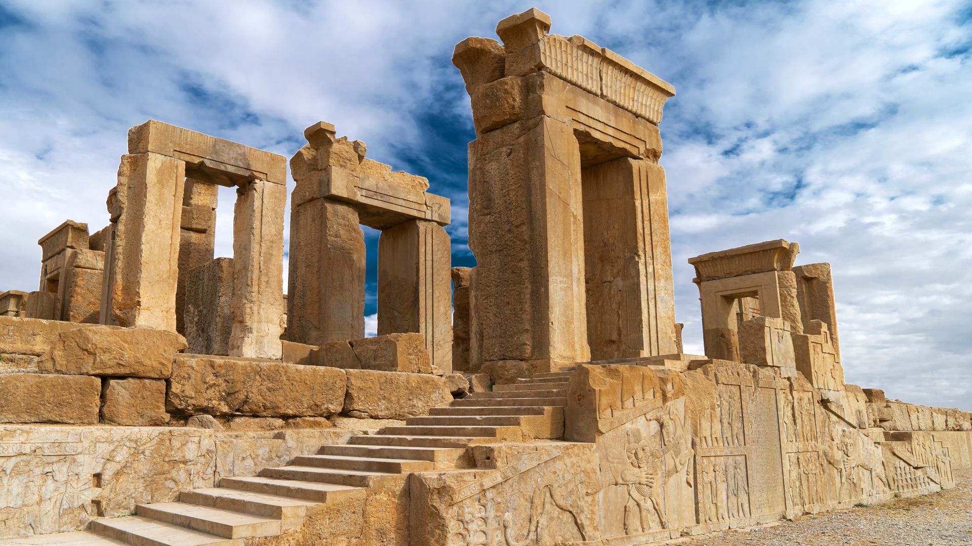 Ancient stone ruins with grand columns and stairs.