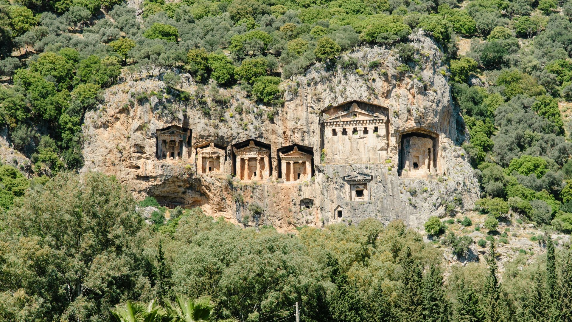 A mountain side with a body of water in front of it