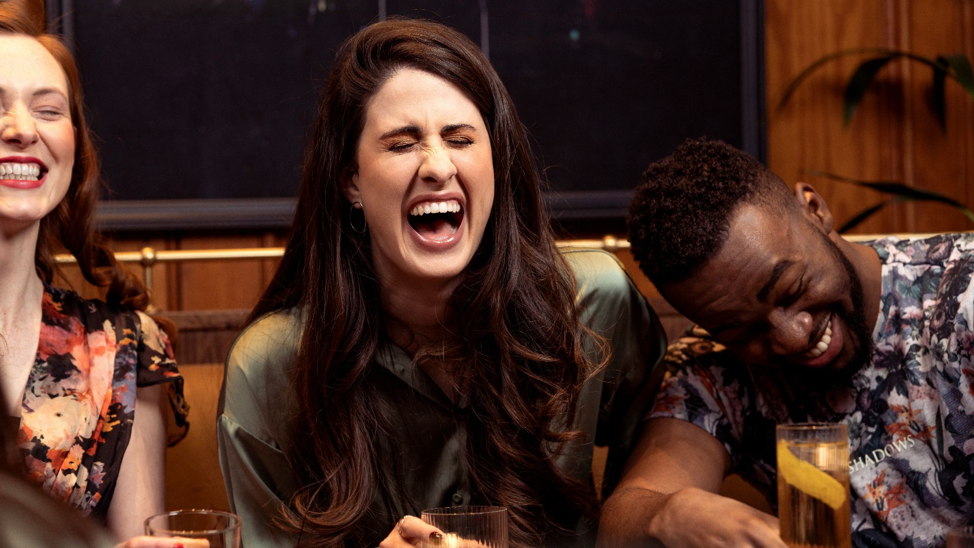 a group of people sitting around a table with drinks