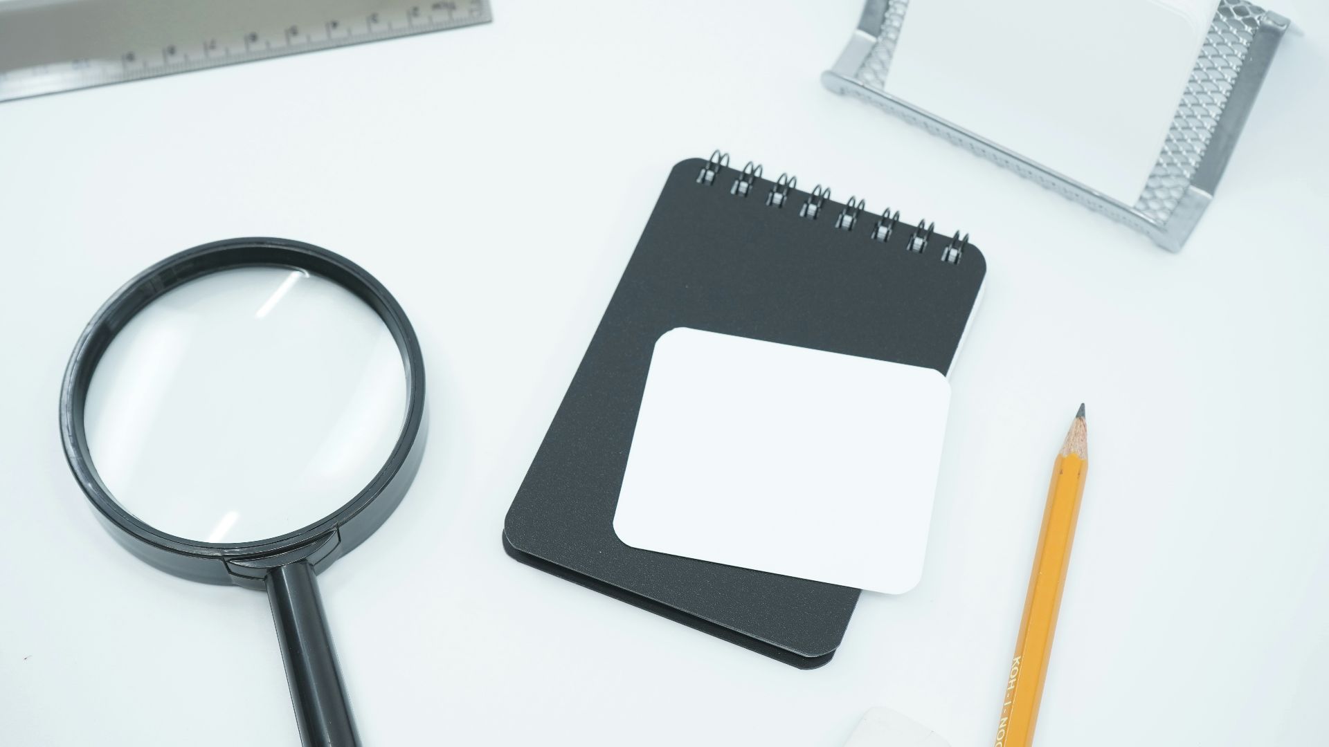 black magnifying glass on white paper