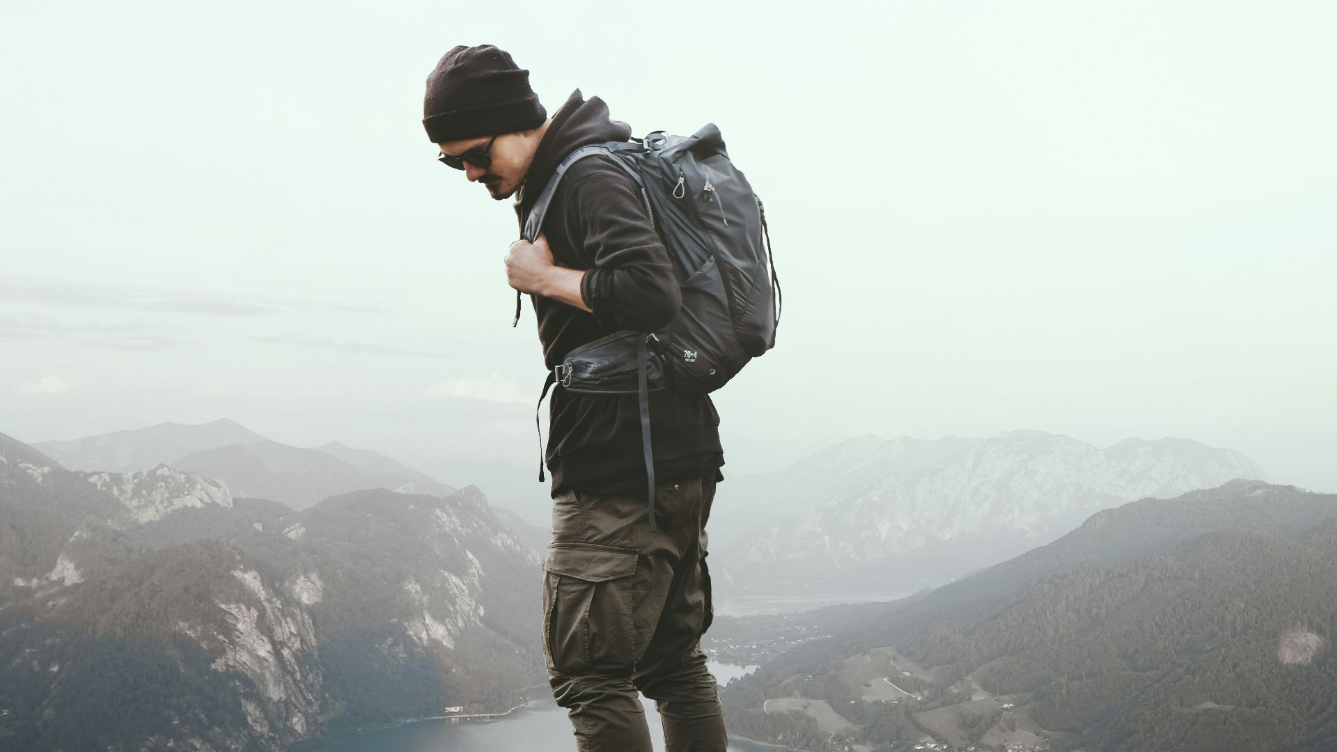a man standing on a rock overlooking a body of water