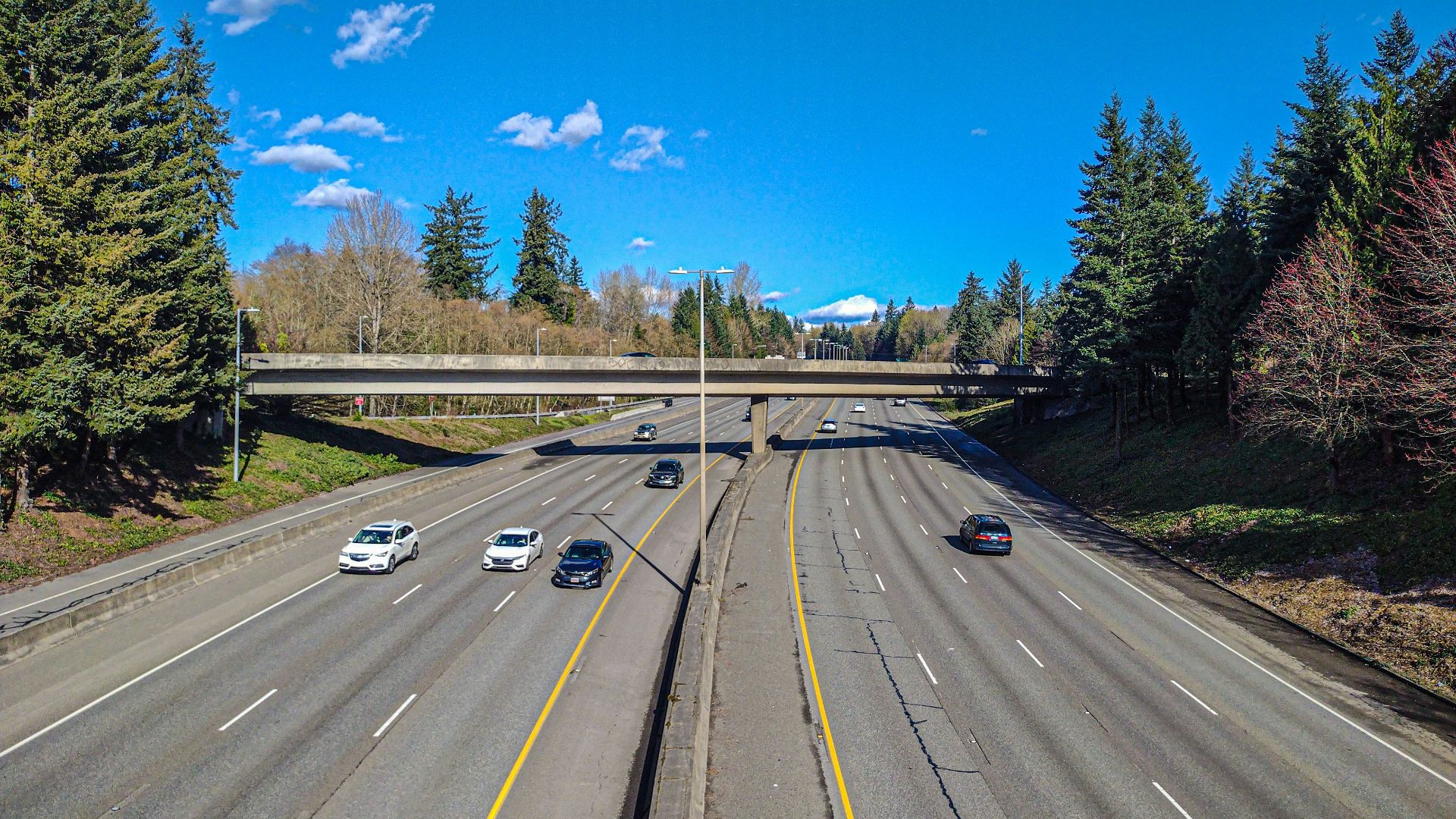 a highway with a bunch of cars driving down it