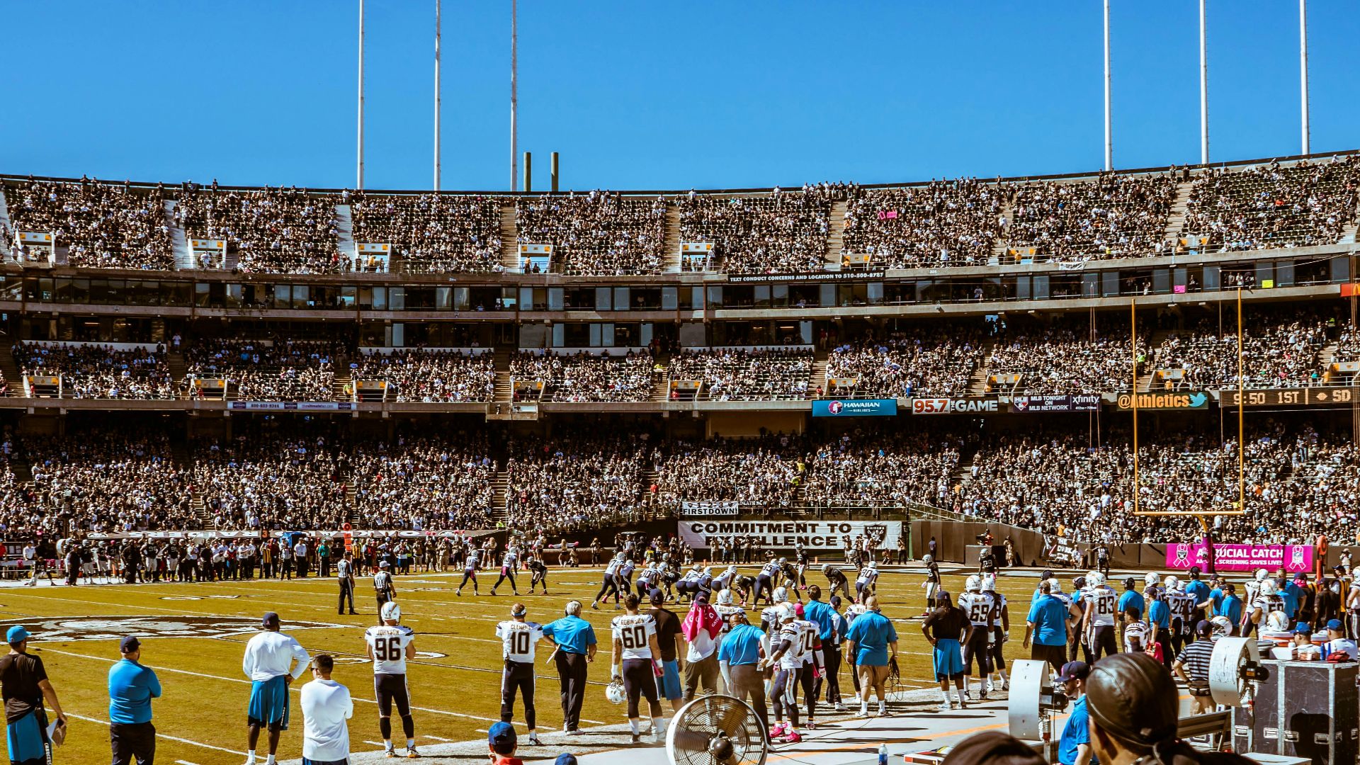group of people watching football game during daytime