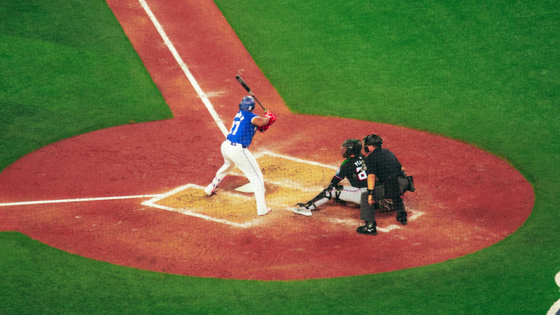 A baseball player holding a bat on top of a field