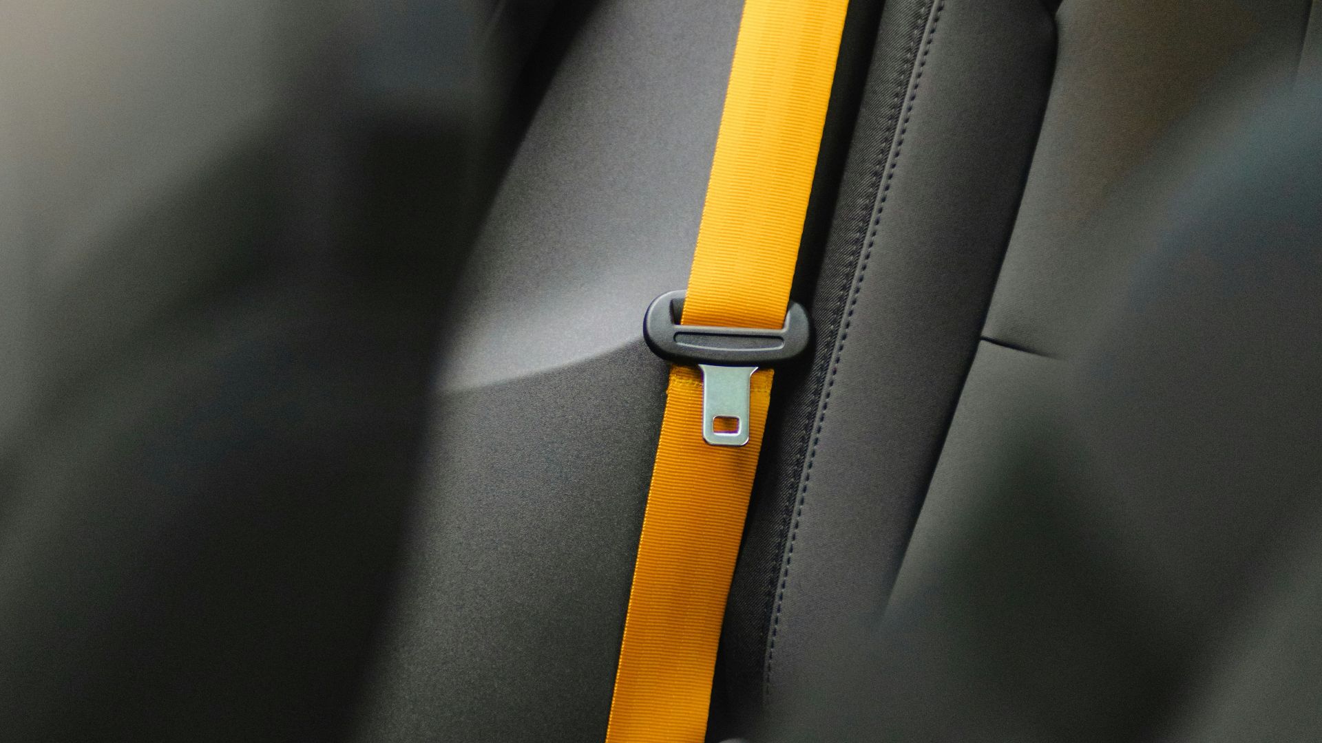 a car seat with a yellow strip on it