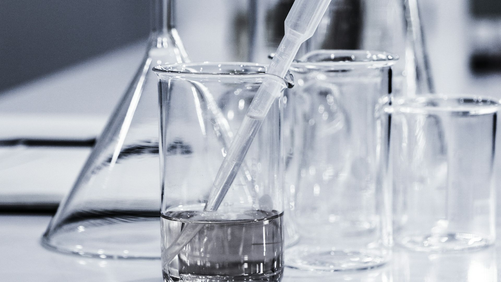 three clear beakers placed on tabletop
