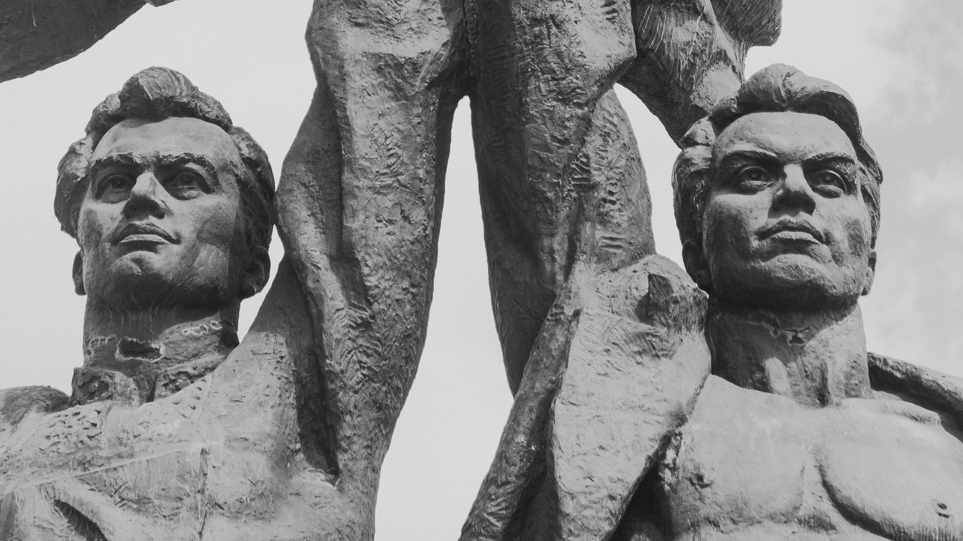 two men raising star statue