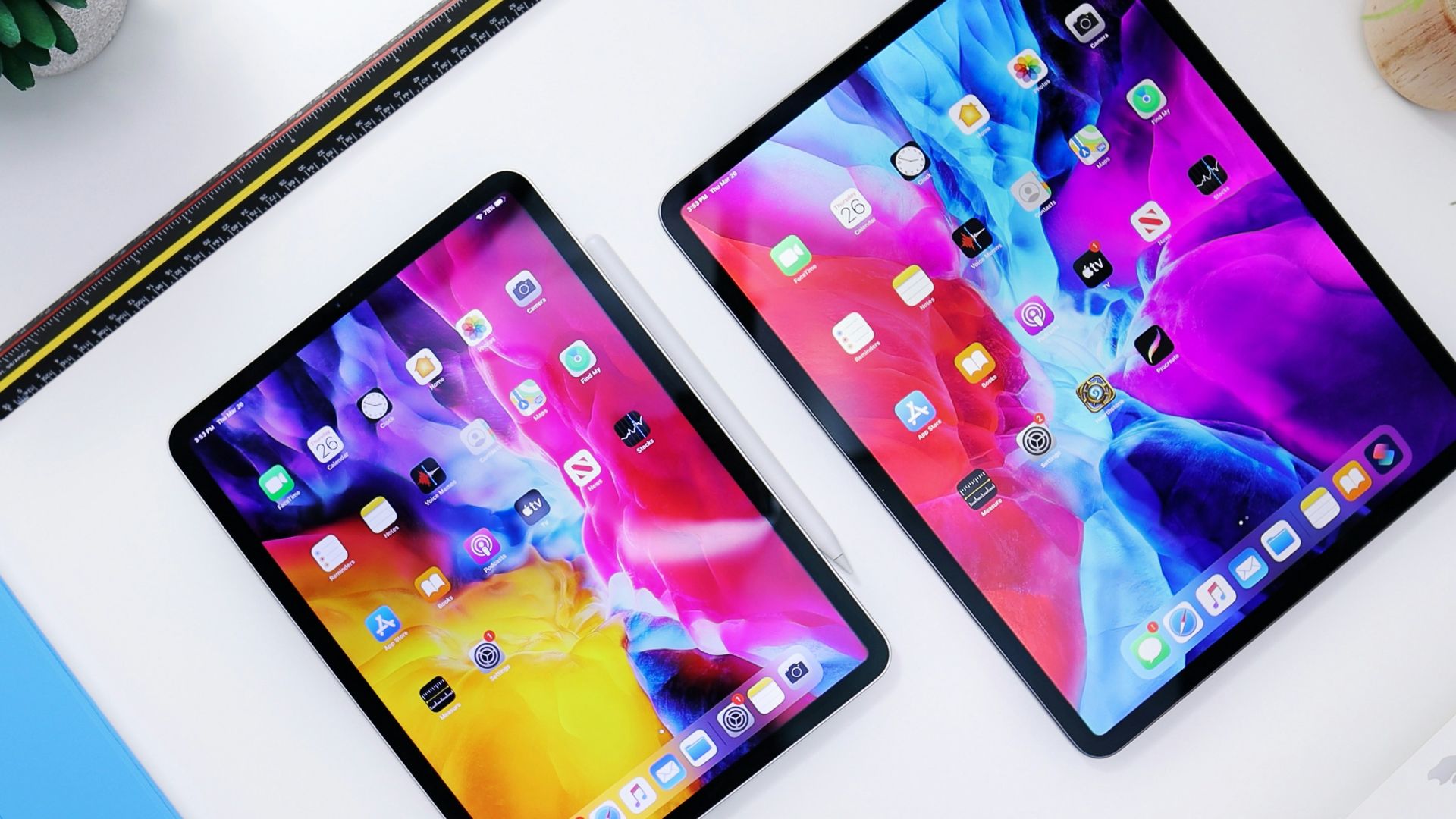 black ipad beside silver iphone 6