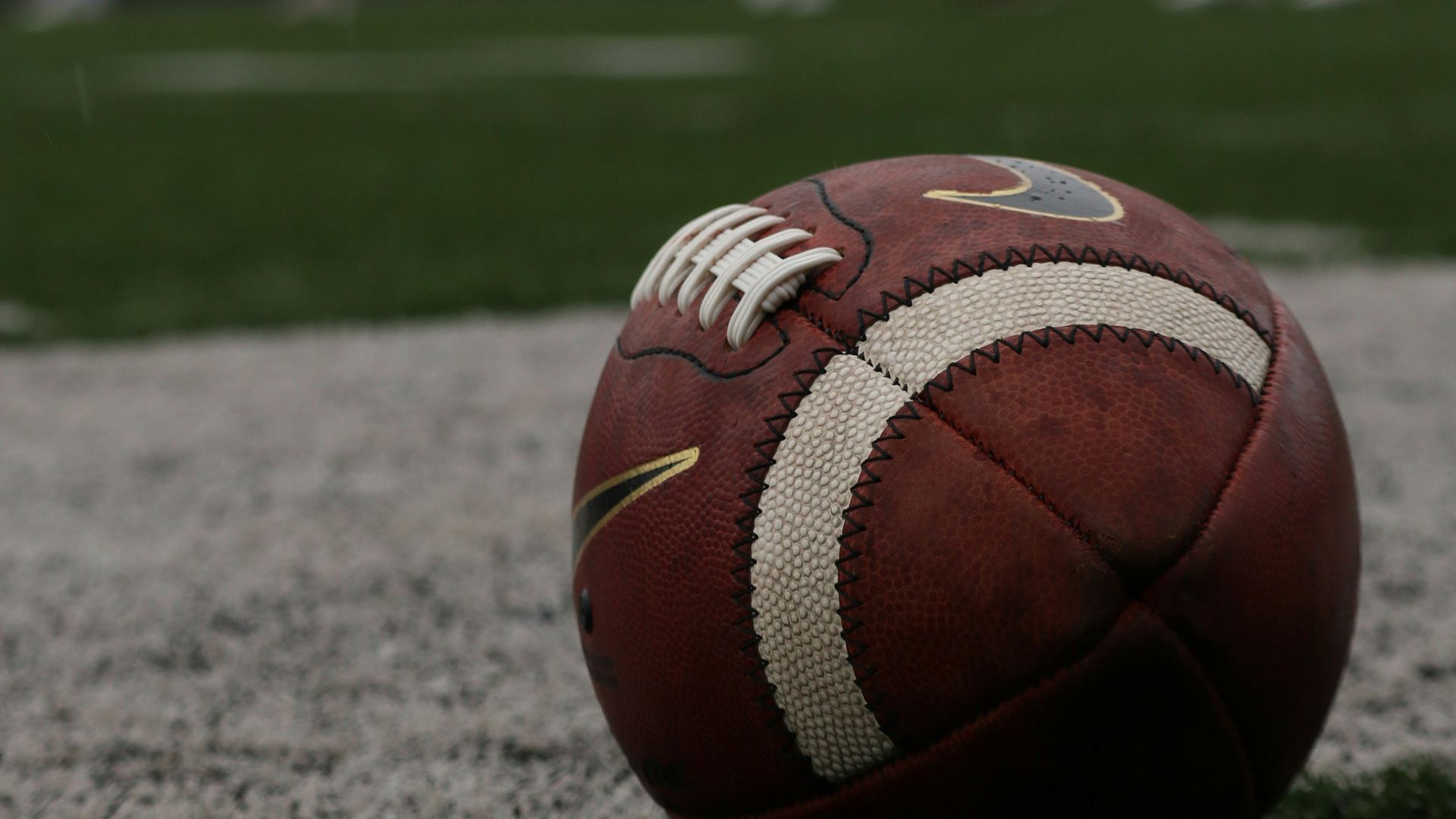 a football sitting on top of a lush green field