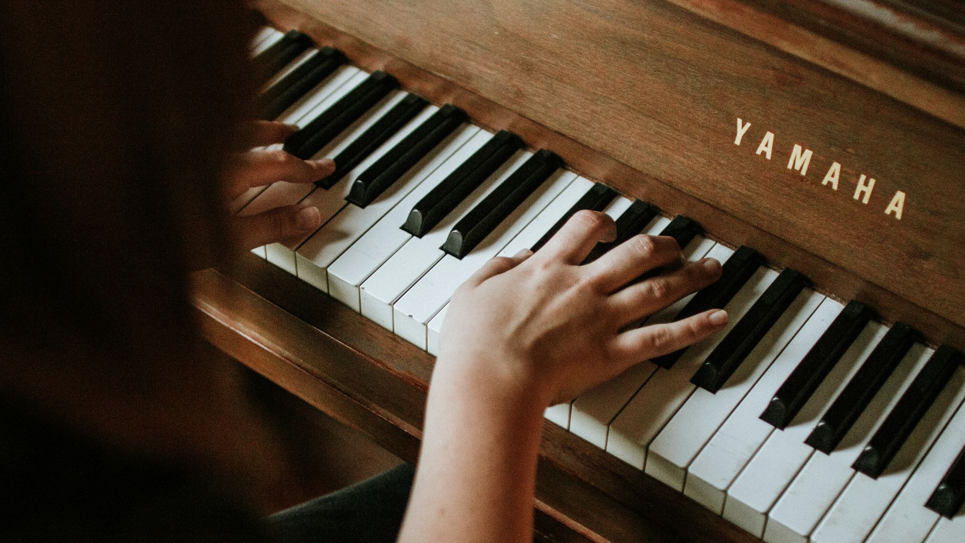 woman playing Yamaha piano