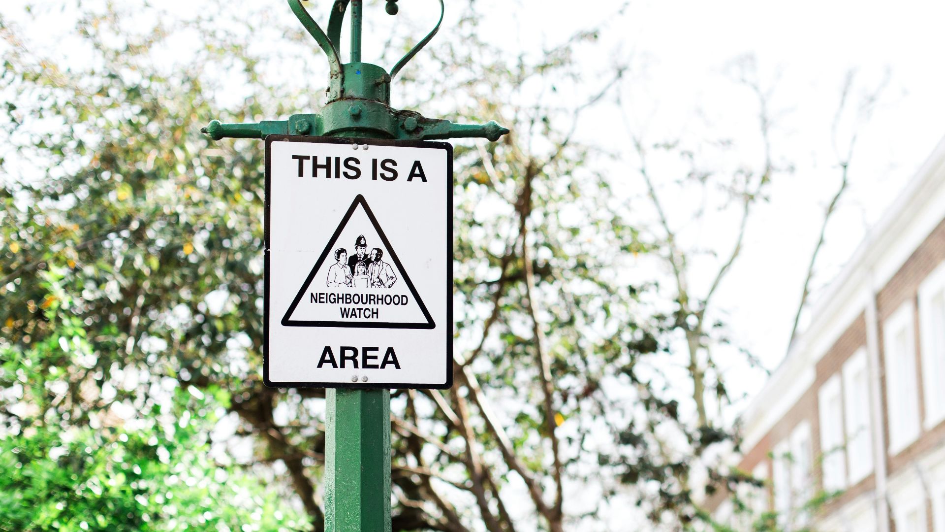 This is a neighbourhood area sign on green post