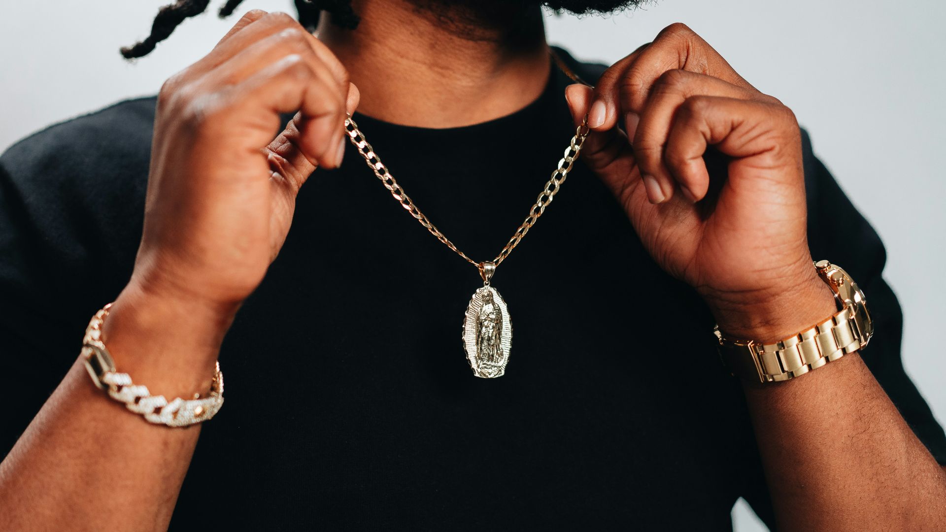 a woman wearing a black shirt and gold bracelets