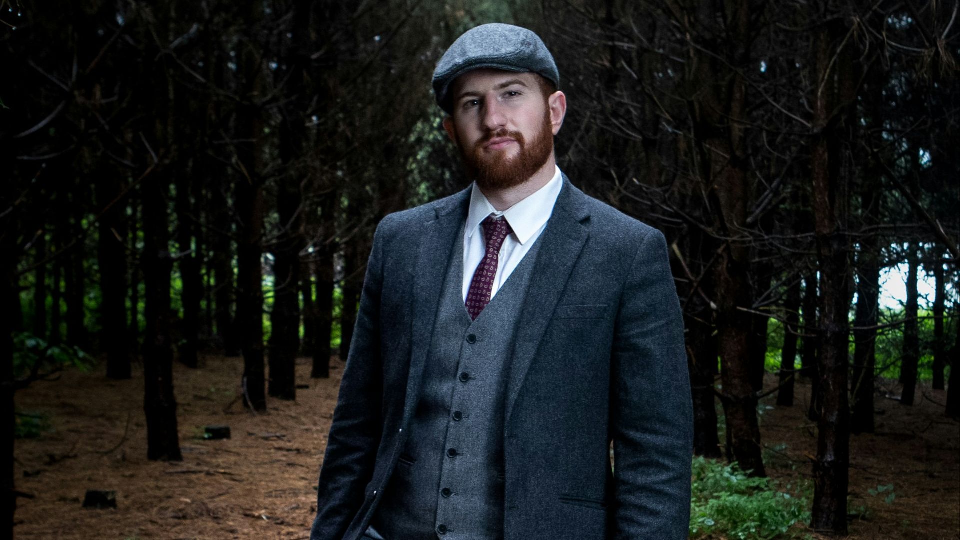 man in suit jacket carrying briefcase