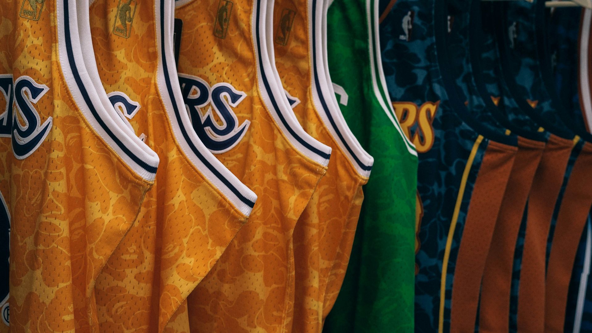 assorted NBA jerseys hanged on clothes hangers