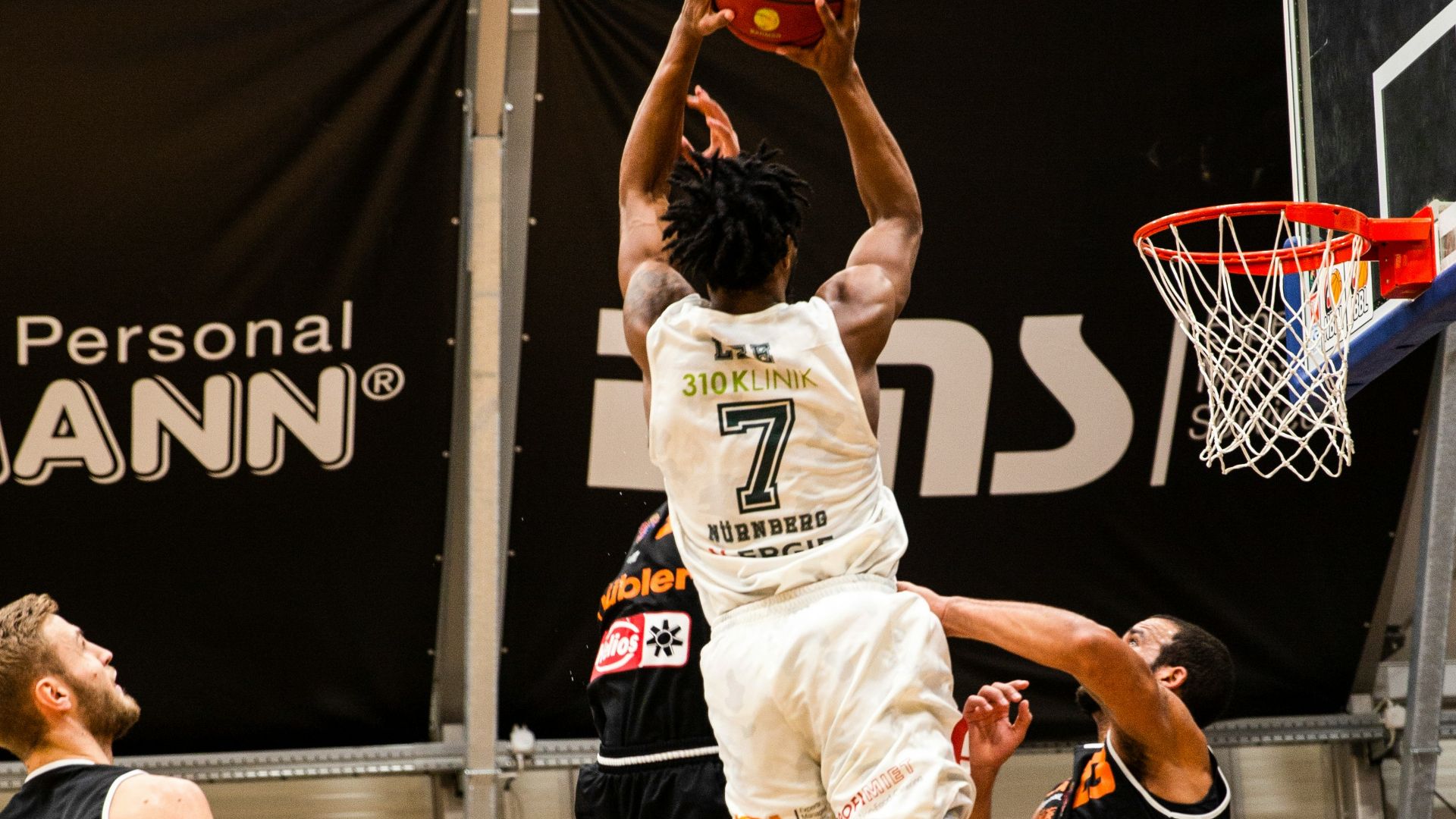 people playing basketball inside court