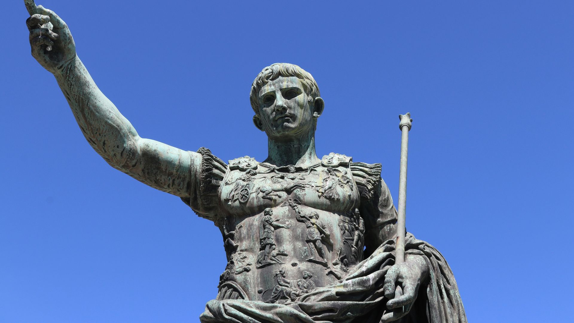 a statue of a person holding a staff