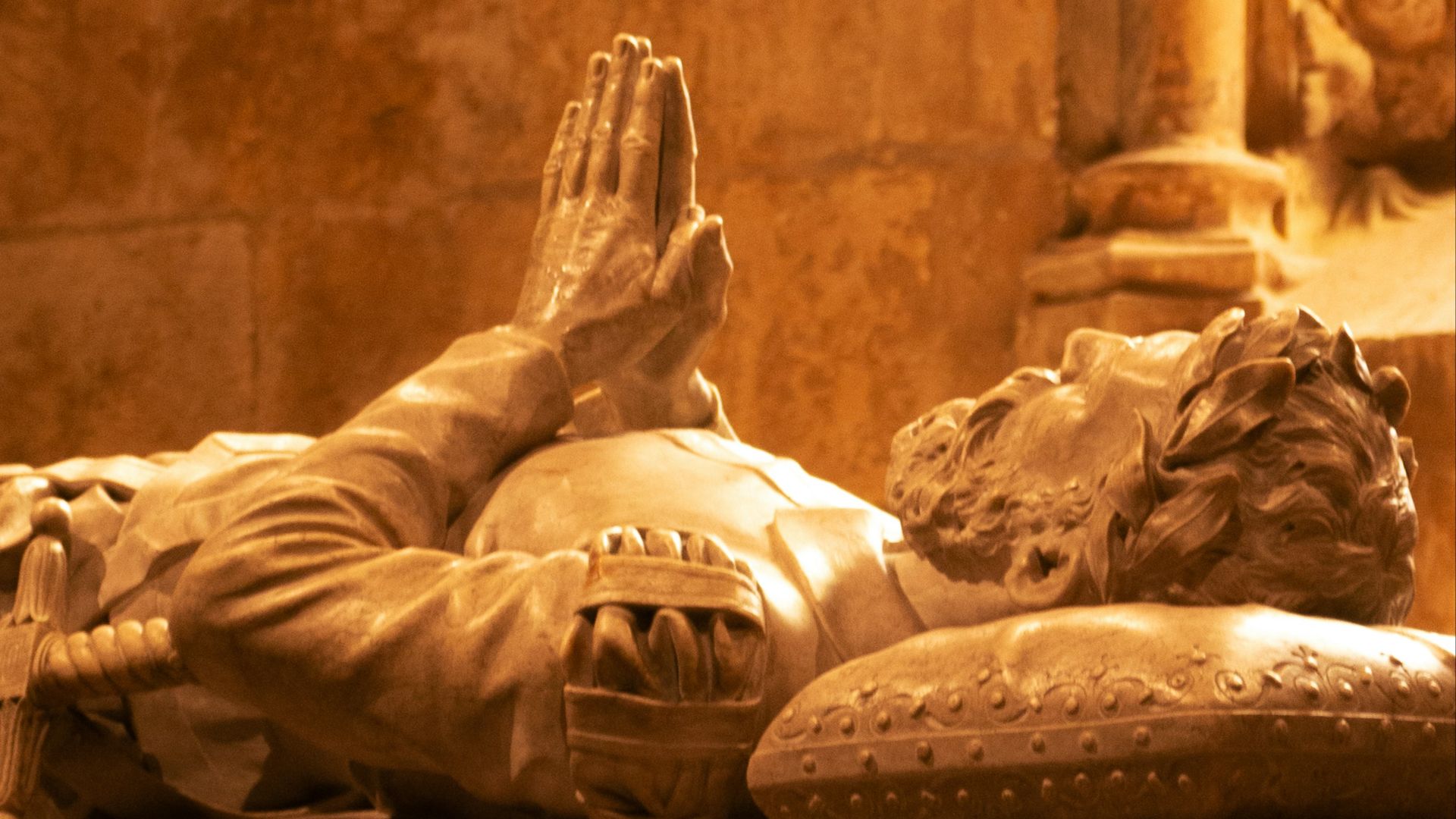 a statue of a man laying on top of a table