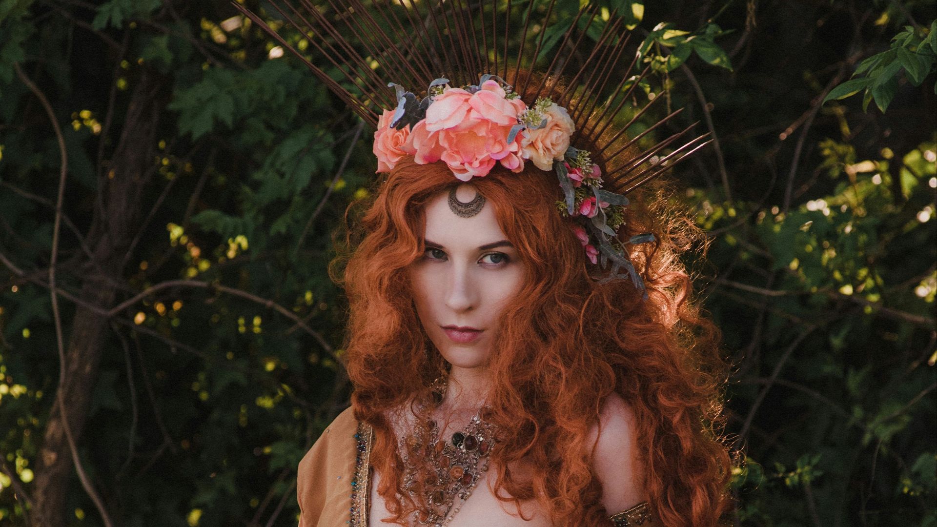 woman in brown dress sitting on brown wooden box