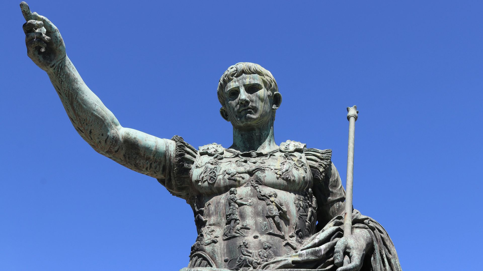 a statue of a person holding a staff