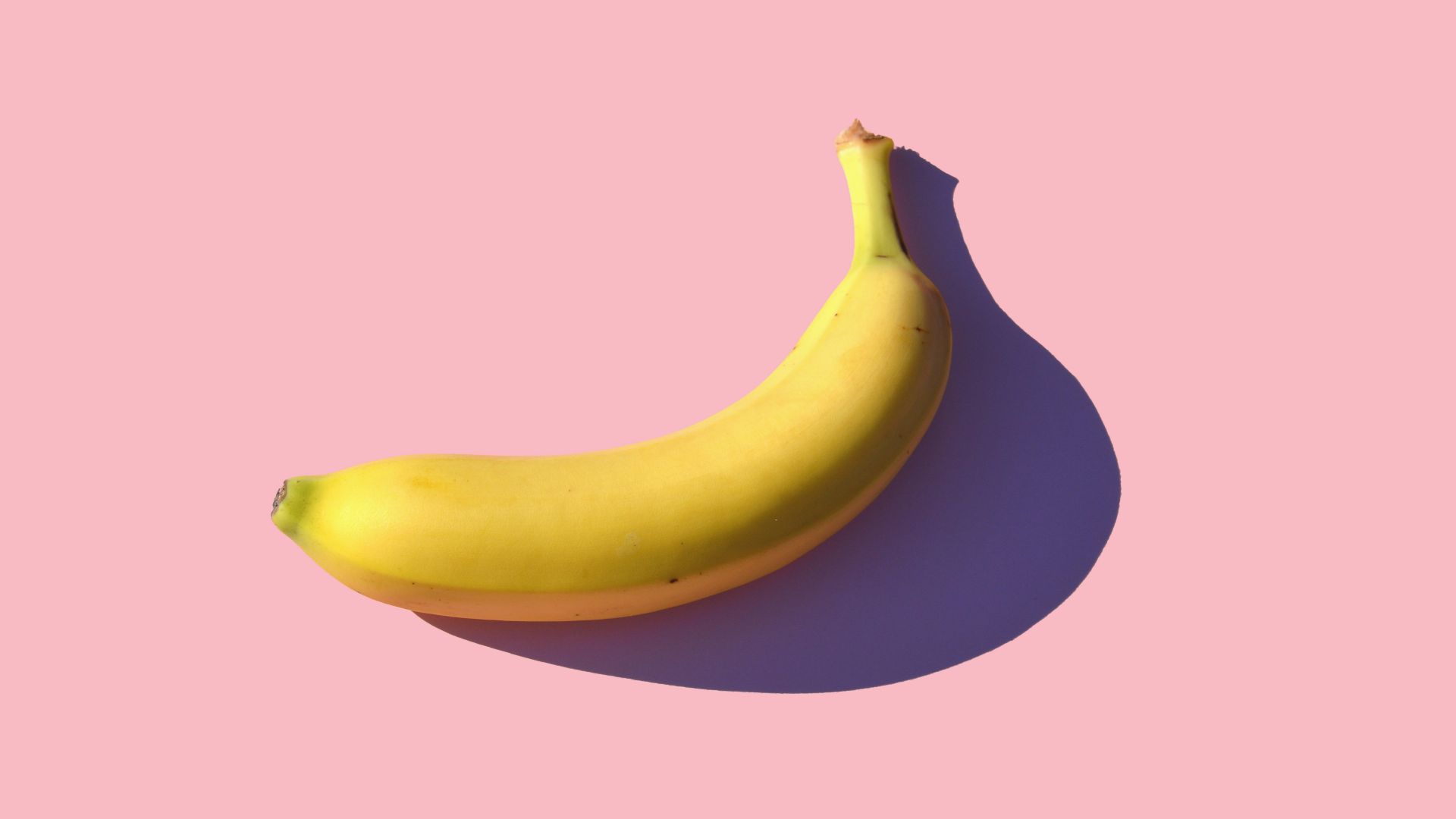 riped banana on pink surface