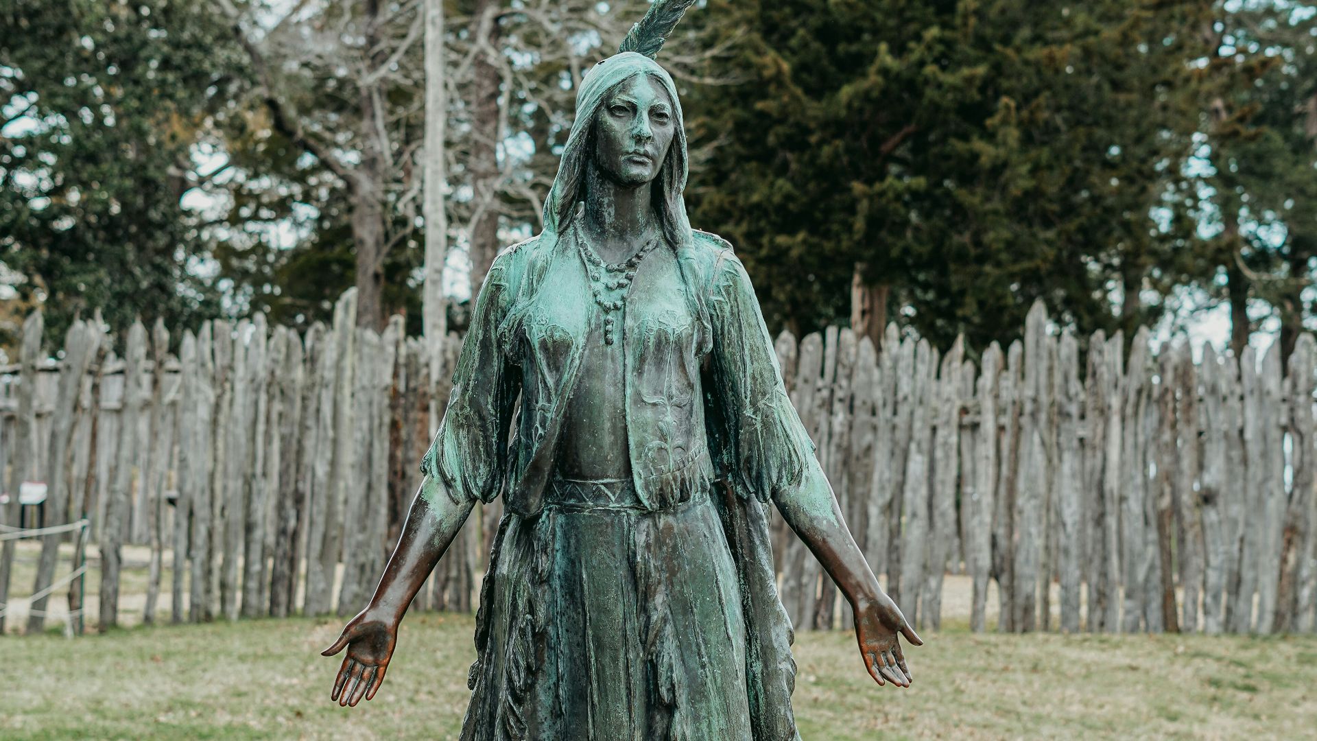 a statue of a woman standing on a rock