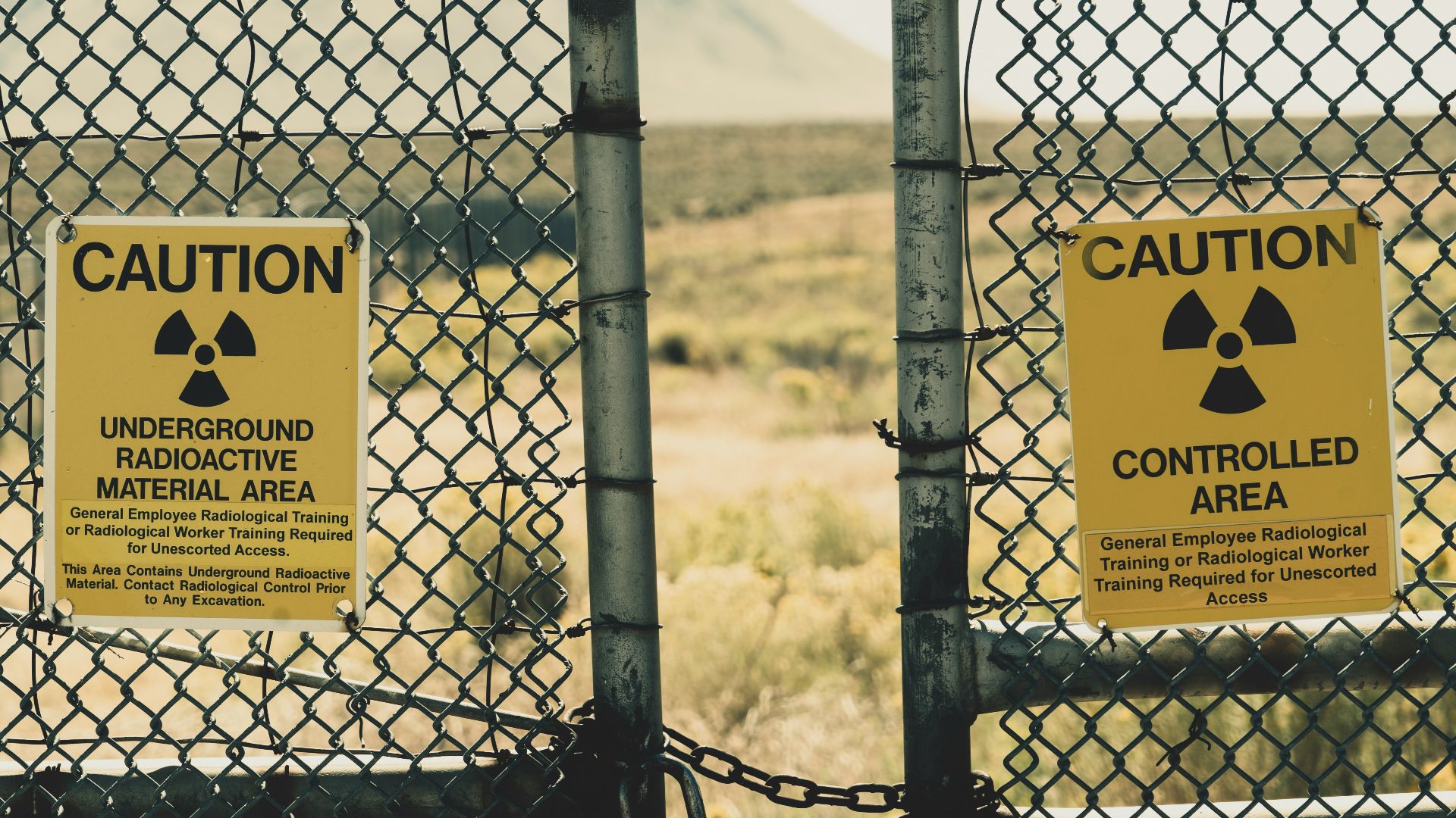 a couple of signs that are on a fence