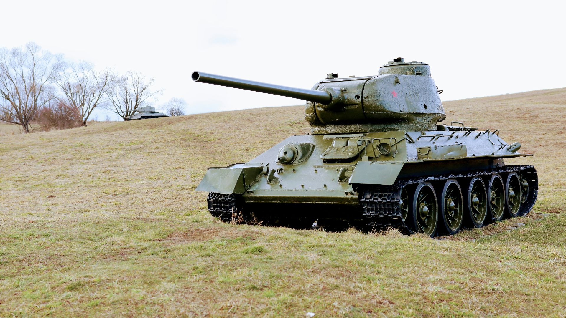 green battle tank on green grass field during daytime