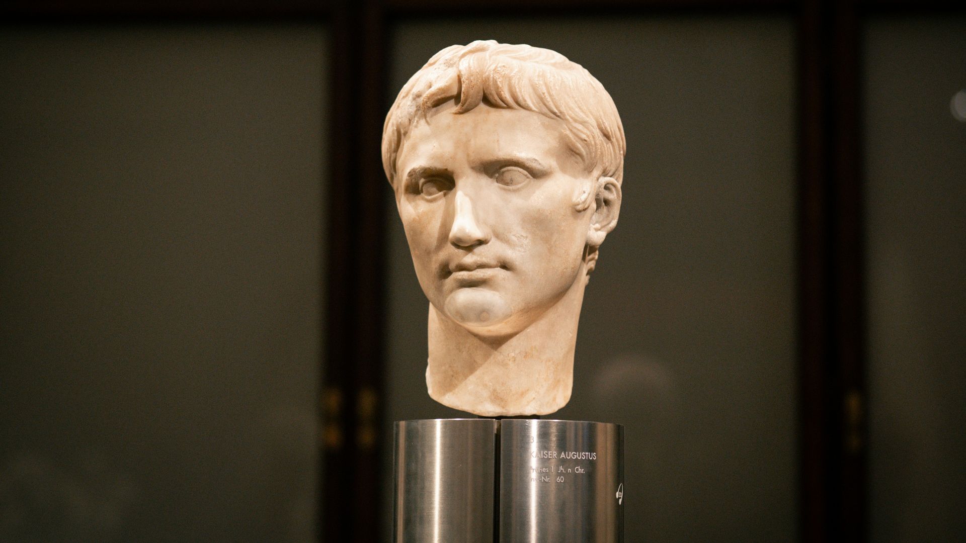 A bust of a man is on display in a museum
