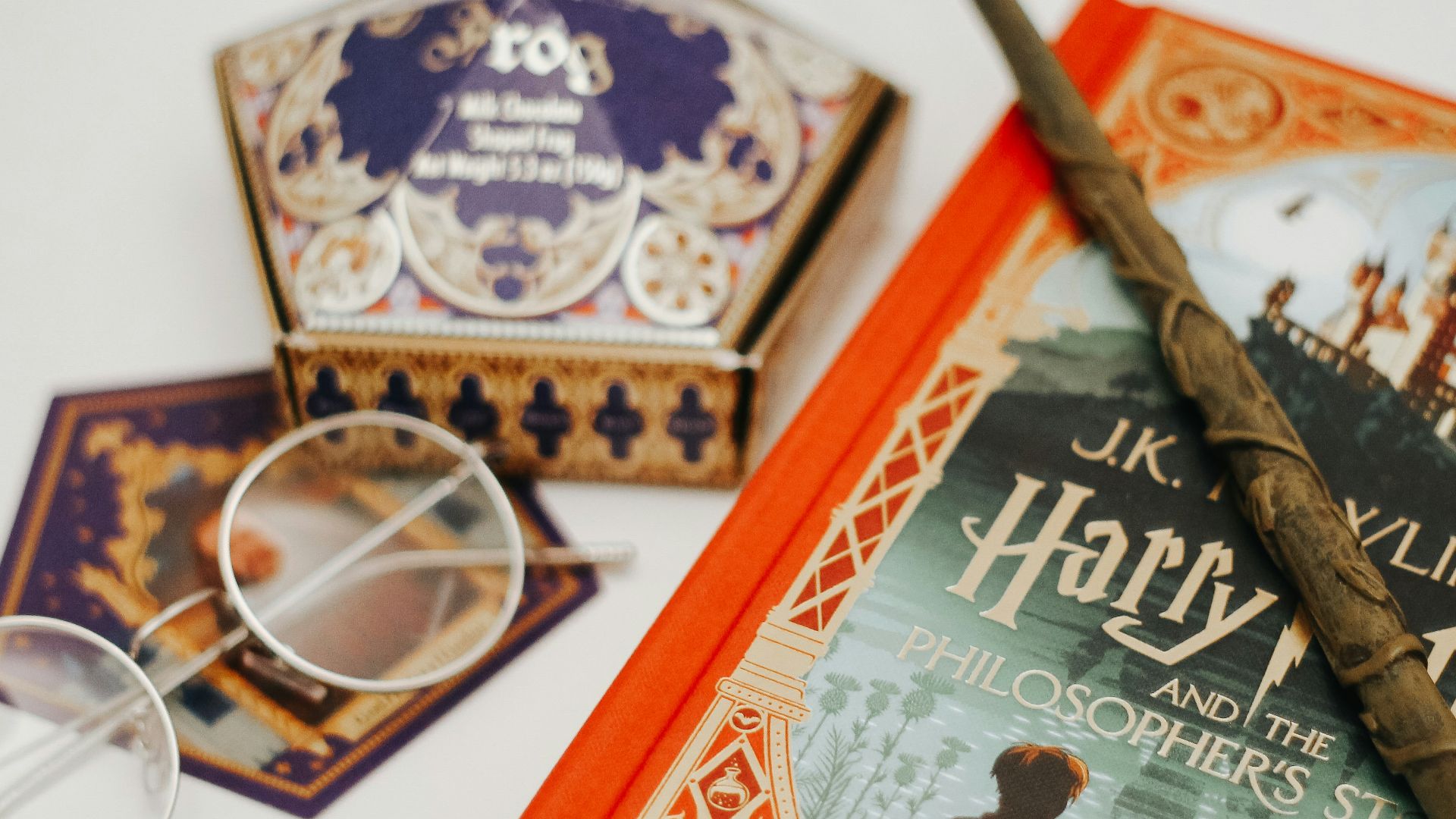 gold framed eyeglasses on red book