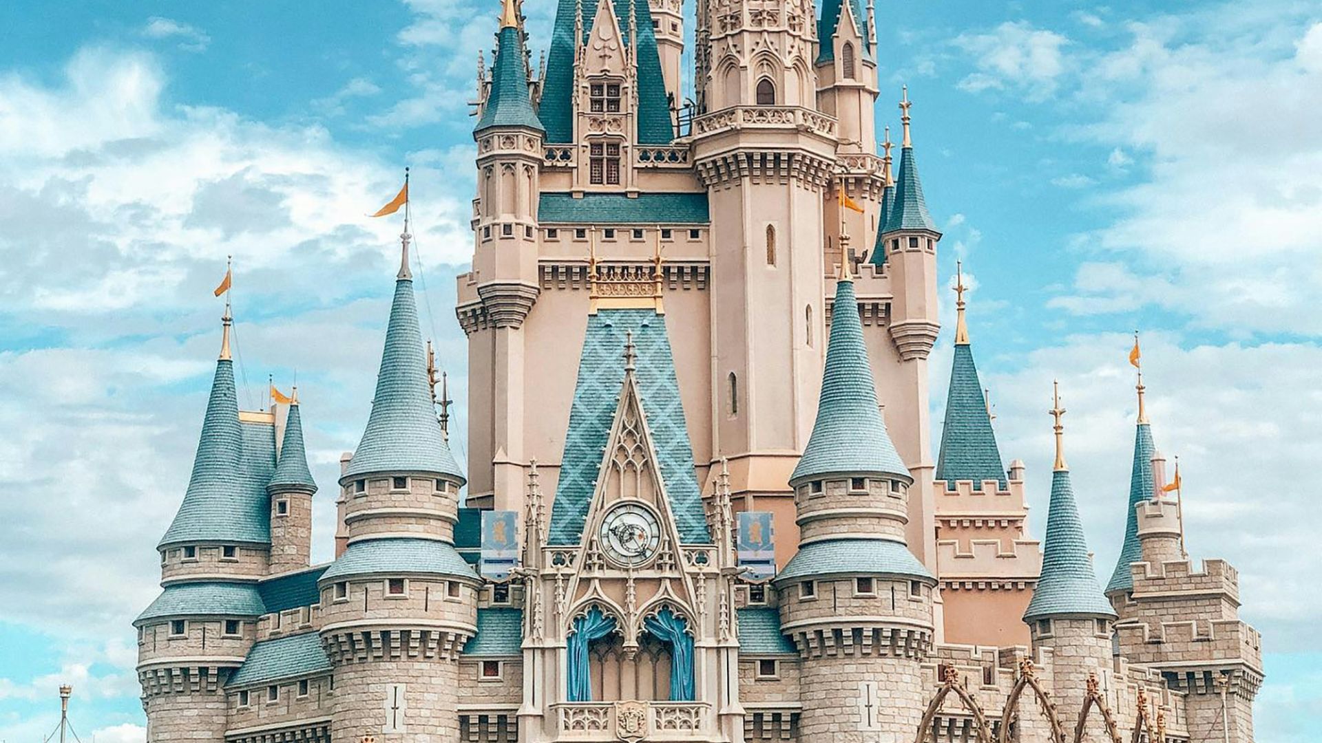 white and blue castle under blue sky and white clouds during daytime
