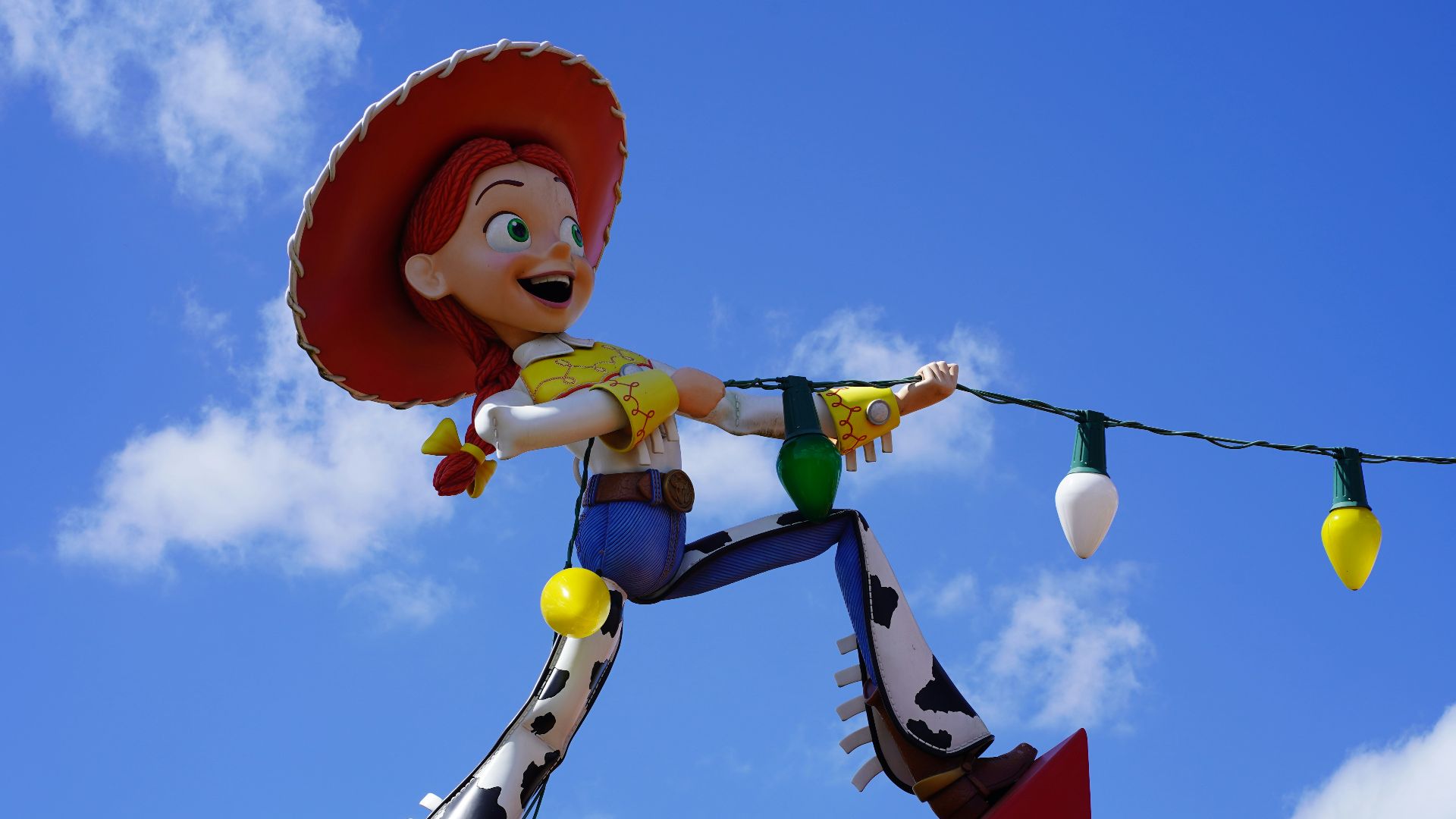 girl in yellow and blue dress holding white balloon