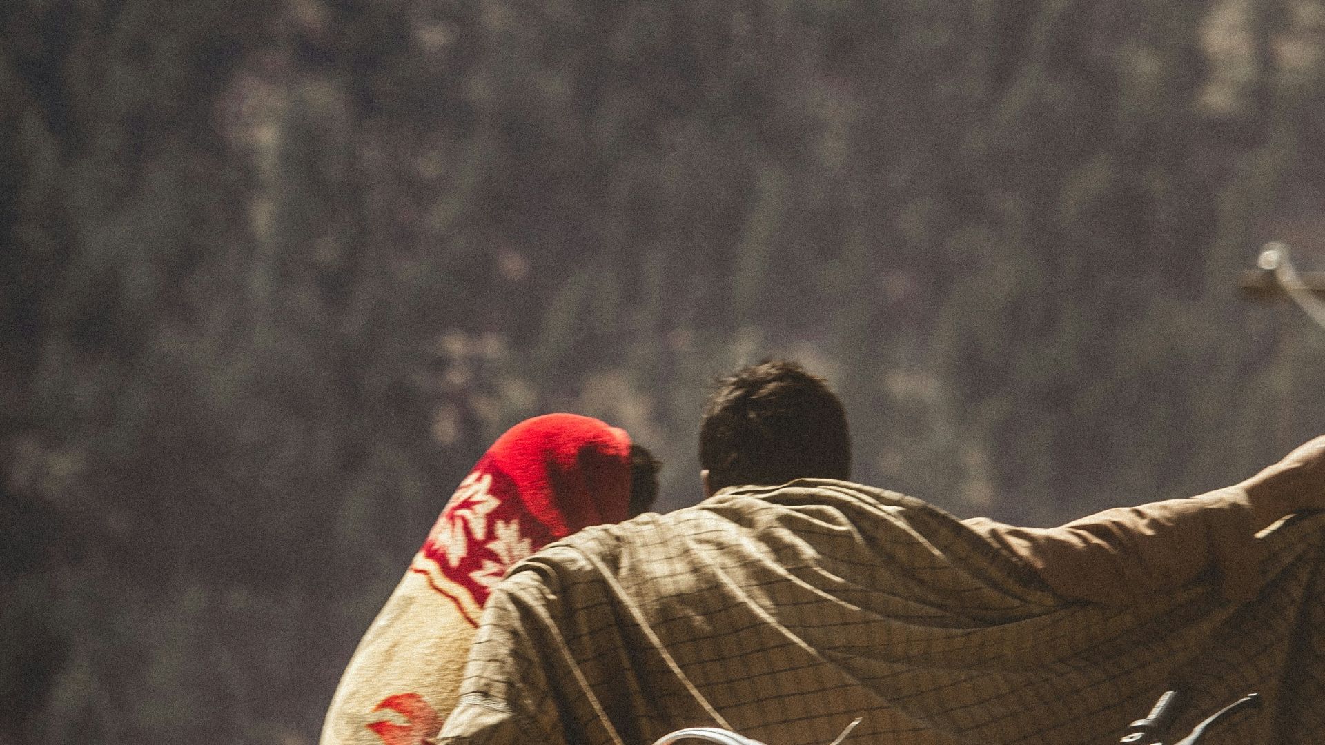 a group of people sitting on top of a mountain