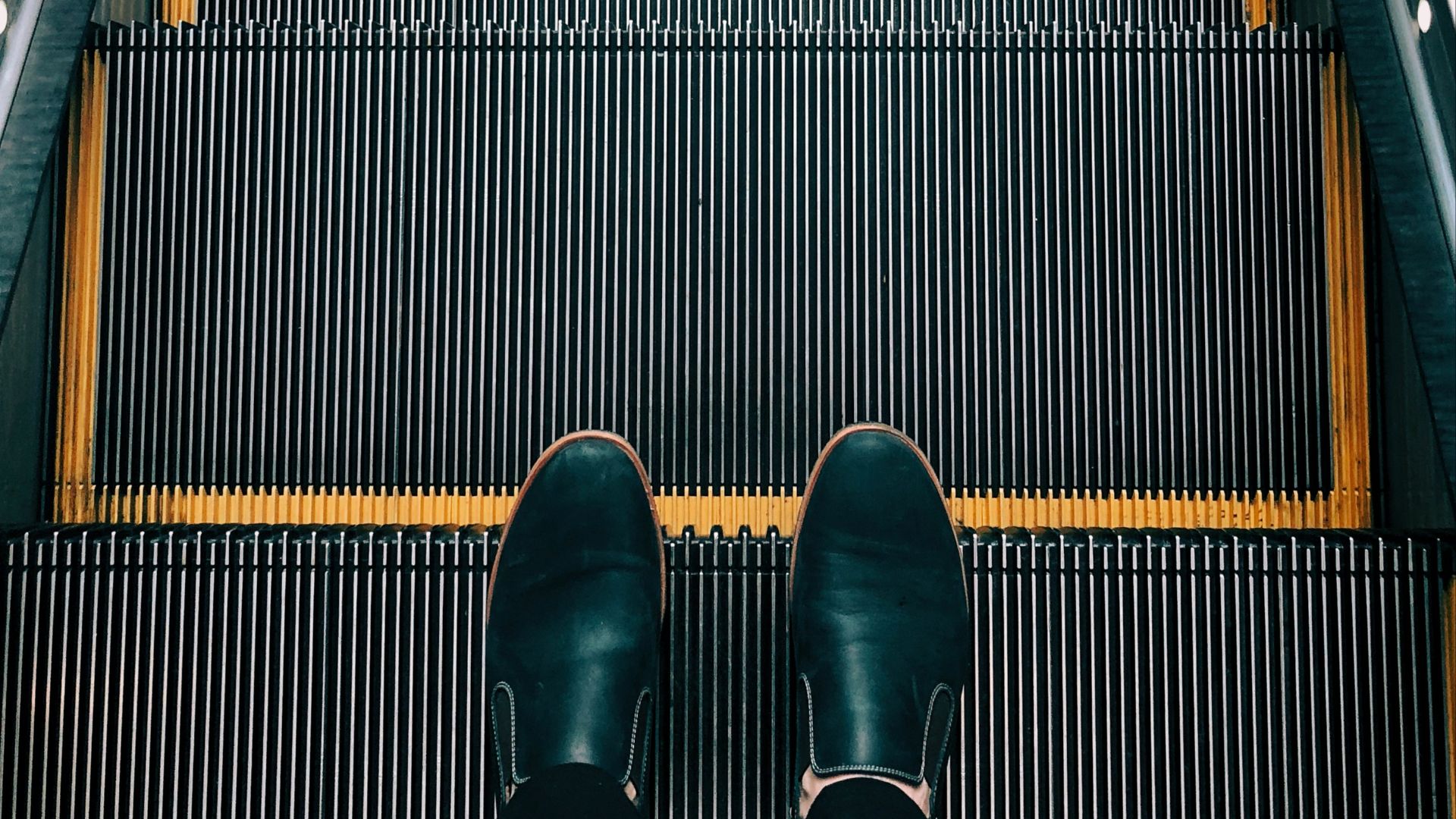 person standing on escalator