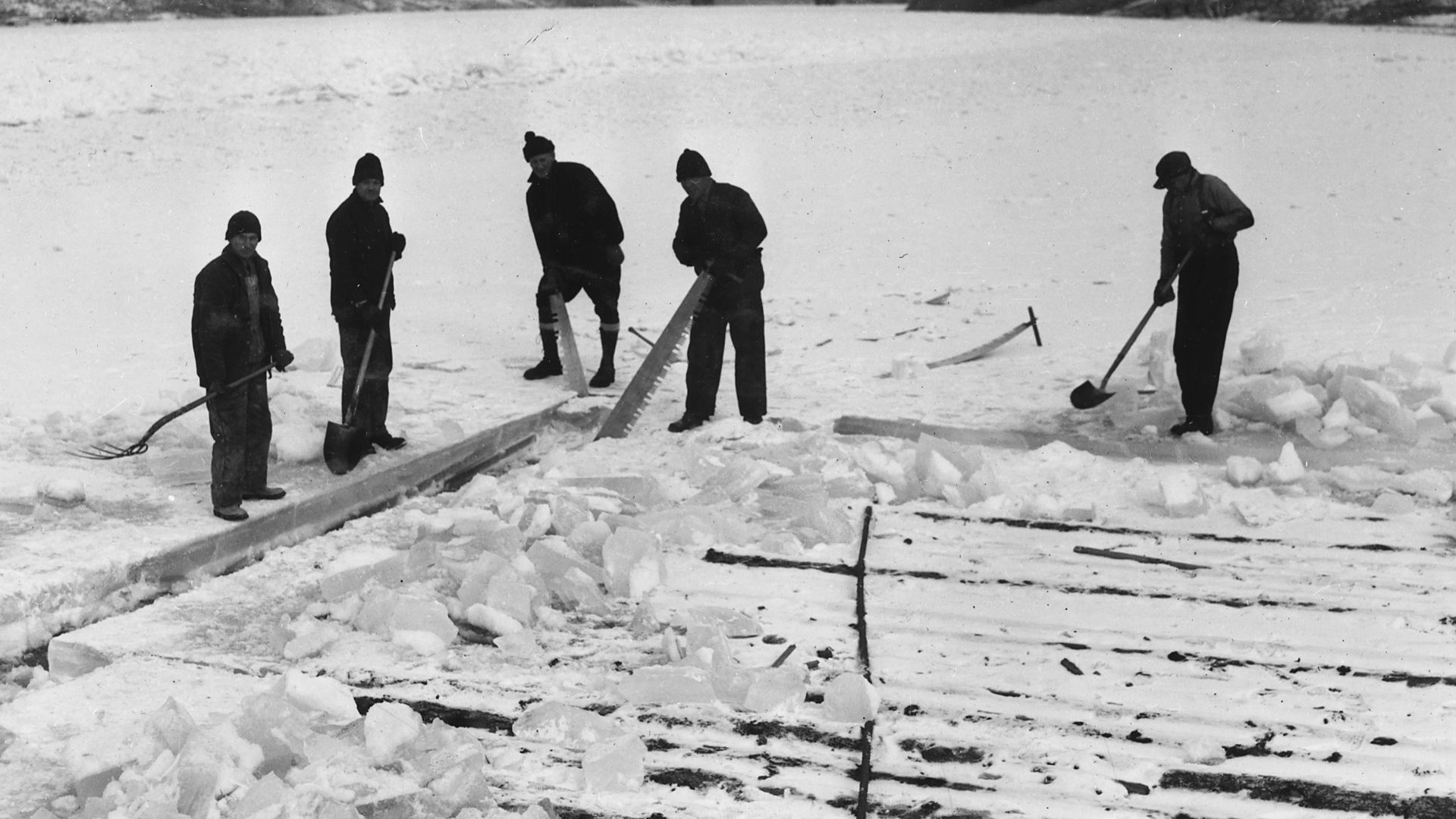 File:Workmen cutting ice around a raft of wood piling, showing the thickness of ice which formed during February - NARA - 294247.jpg