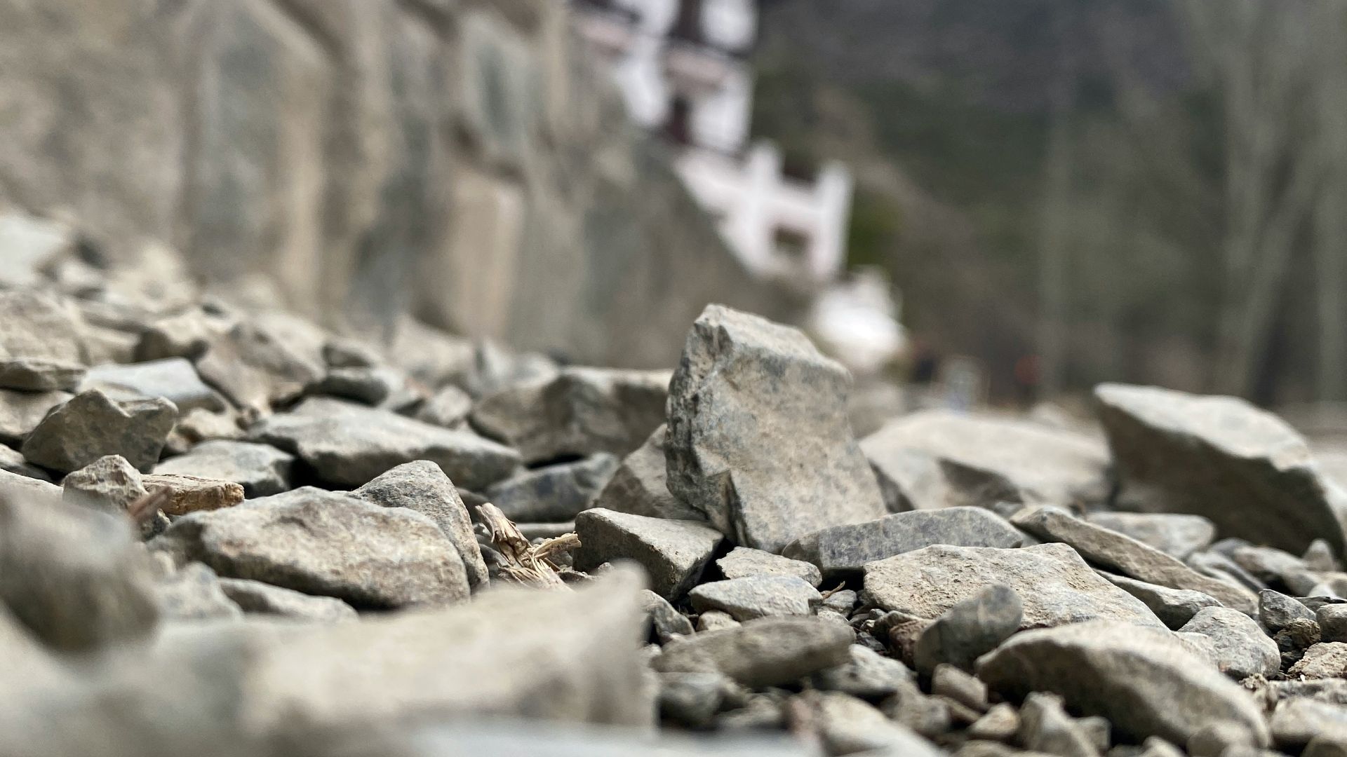 a river with rocks and a building in the background