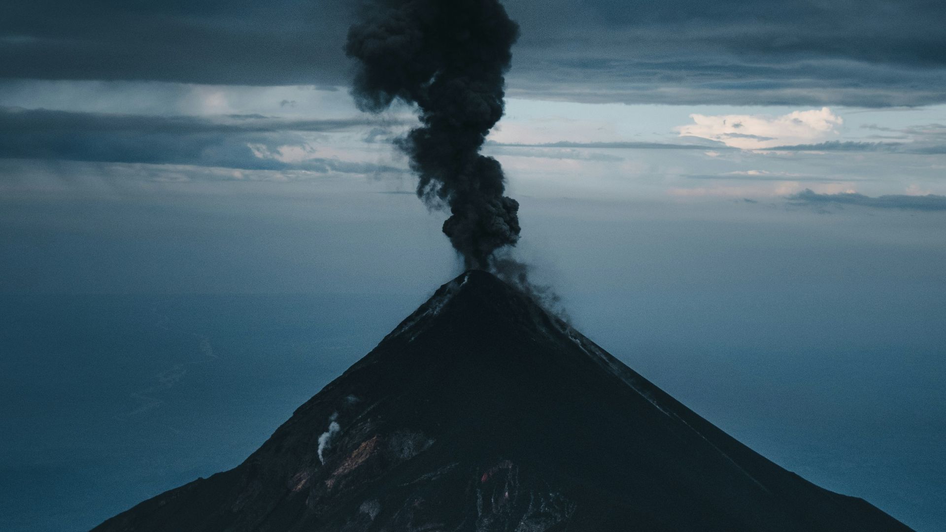 a volcano erupting with smoke