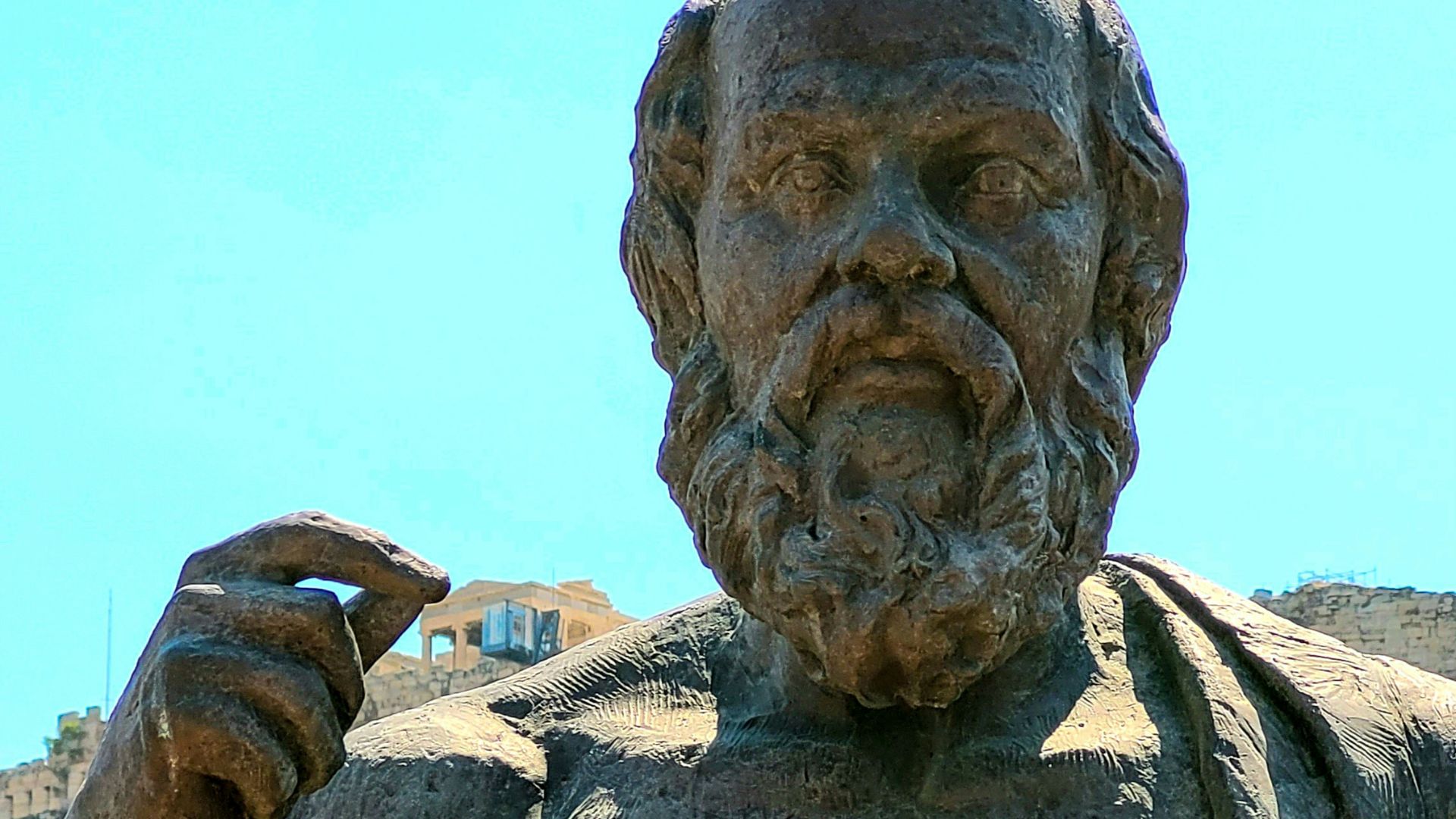 a statue of a man holding a book