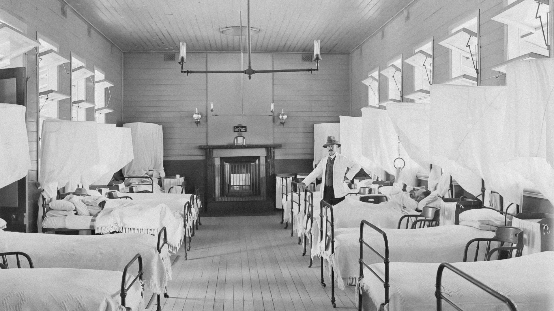 a black and white photo of a hospital room