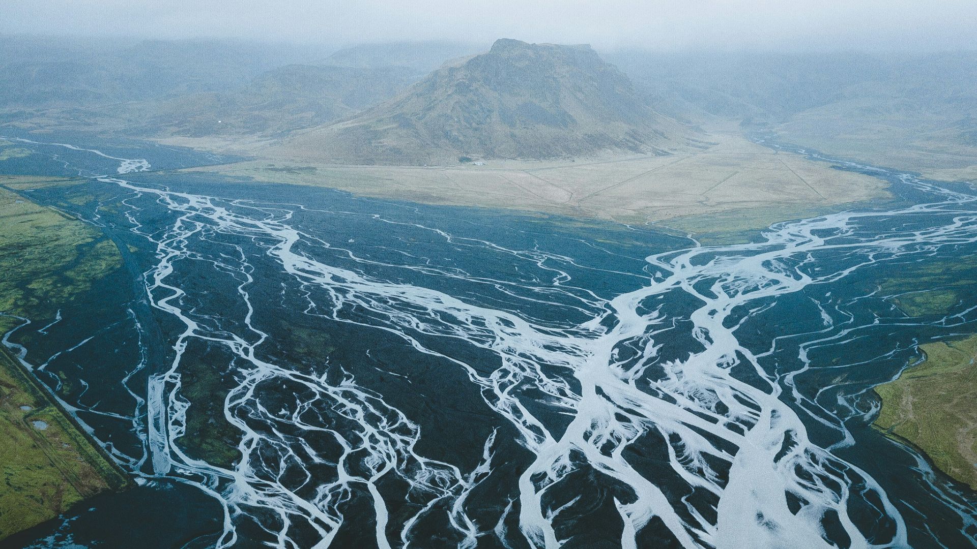 mountain surrounded with body of water