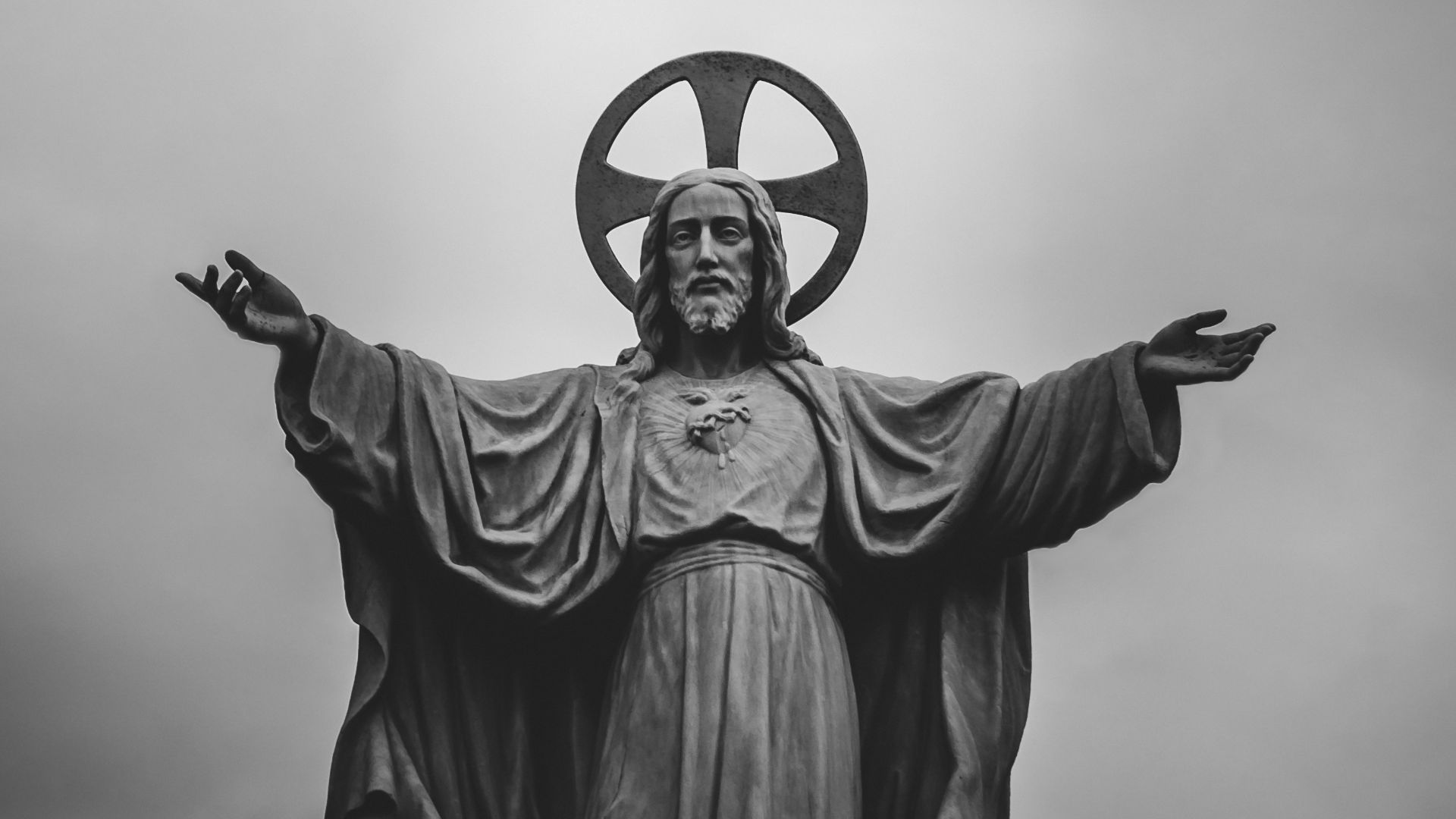 grayscale photograph of Jesus Christ statue