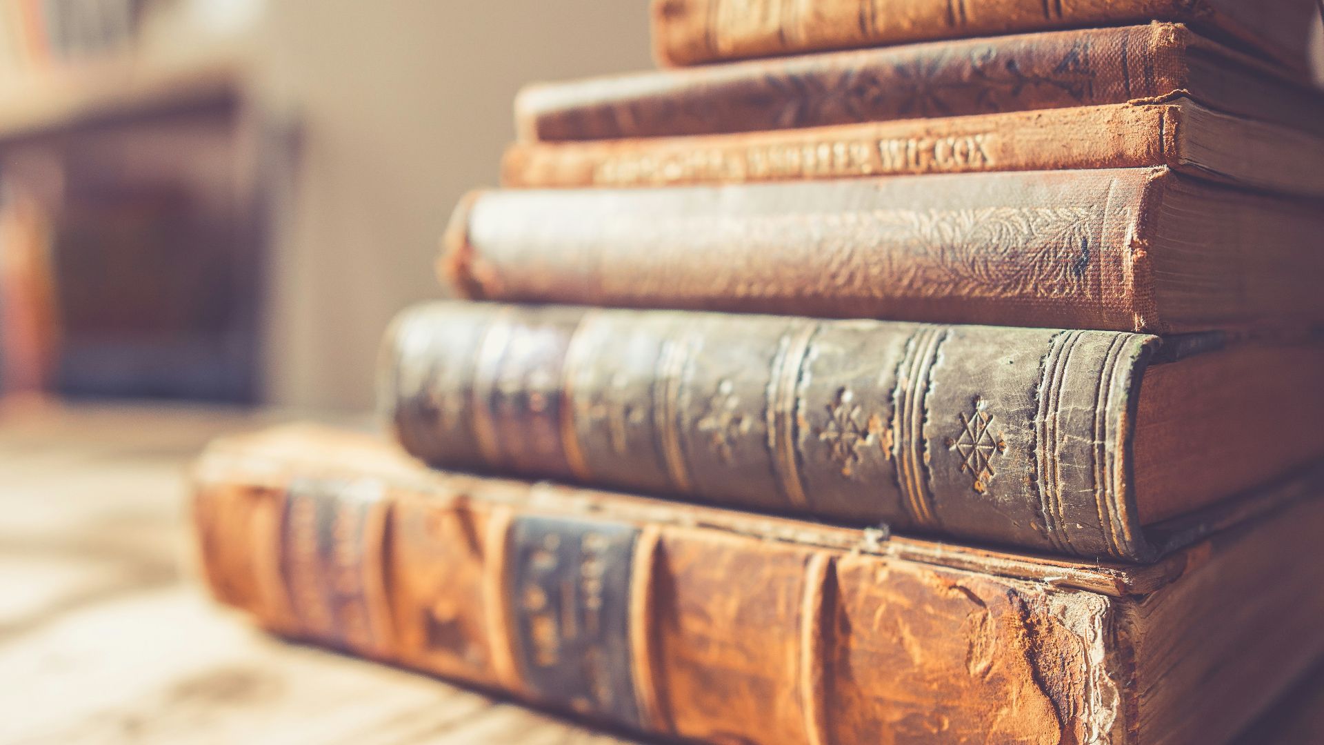 stack of six brown hardbound books