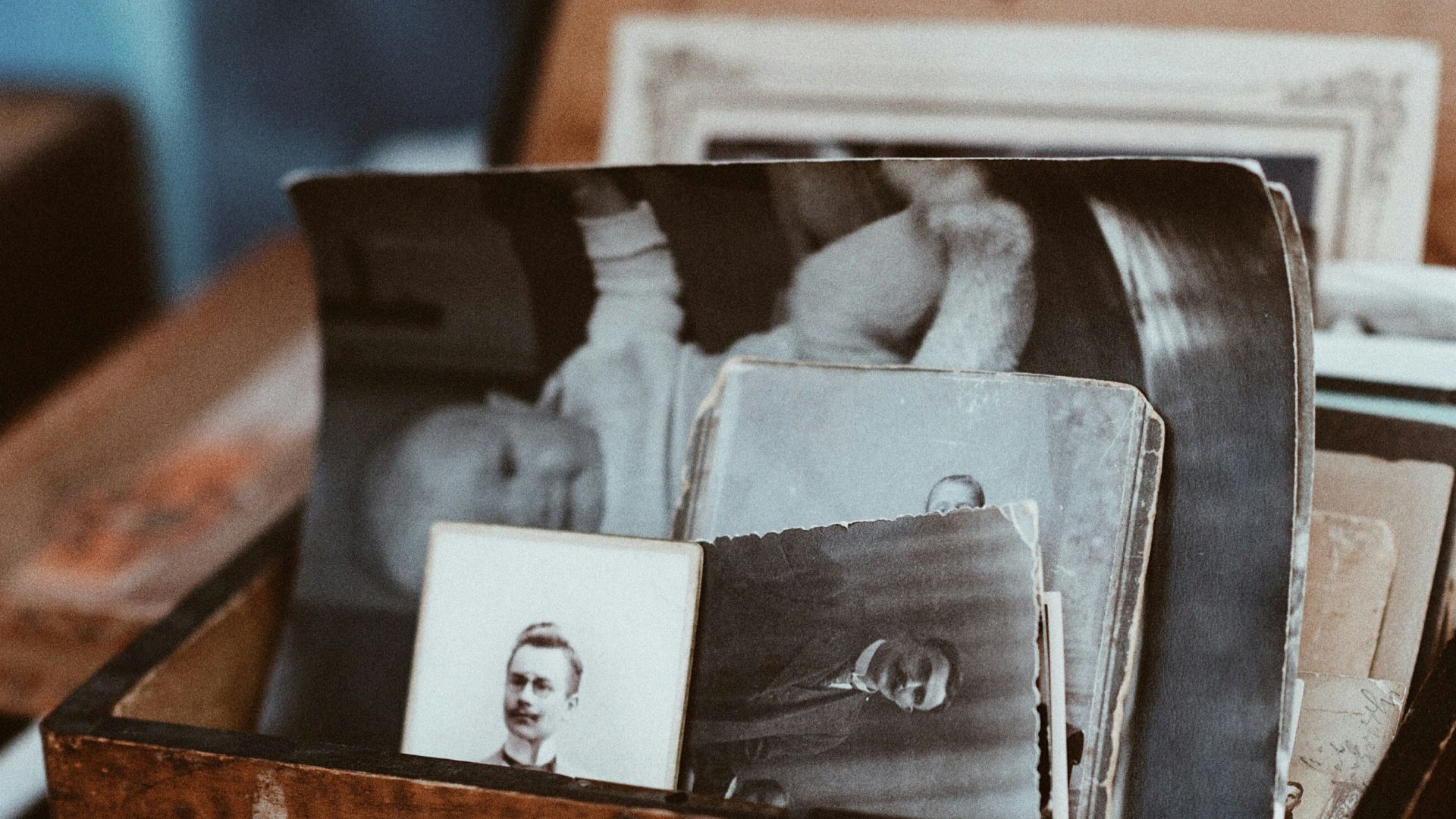 old photos in brown wooden chest
