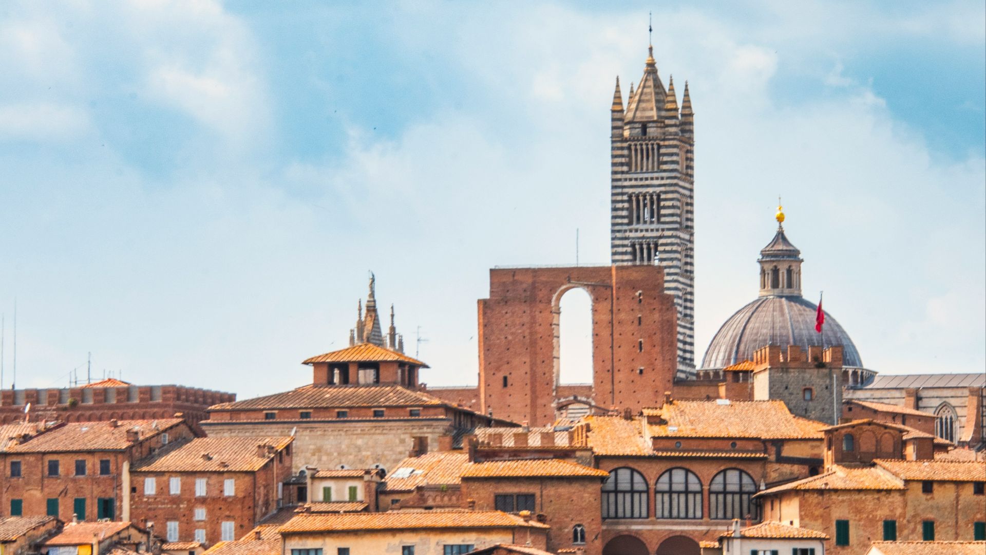 a view of a city with a clock tower in the background